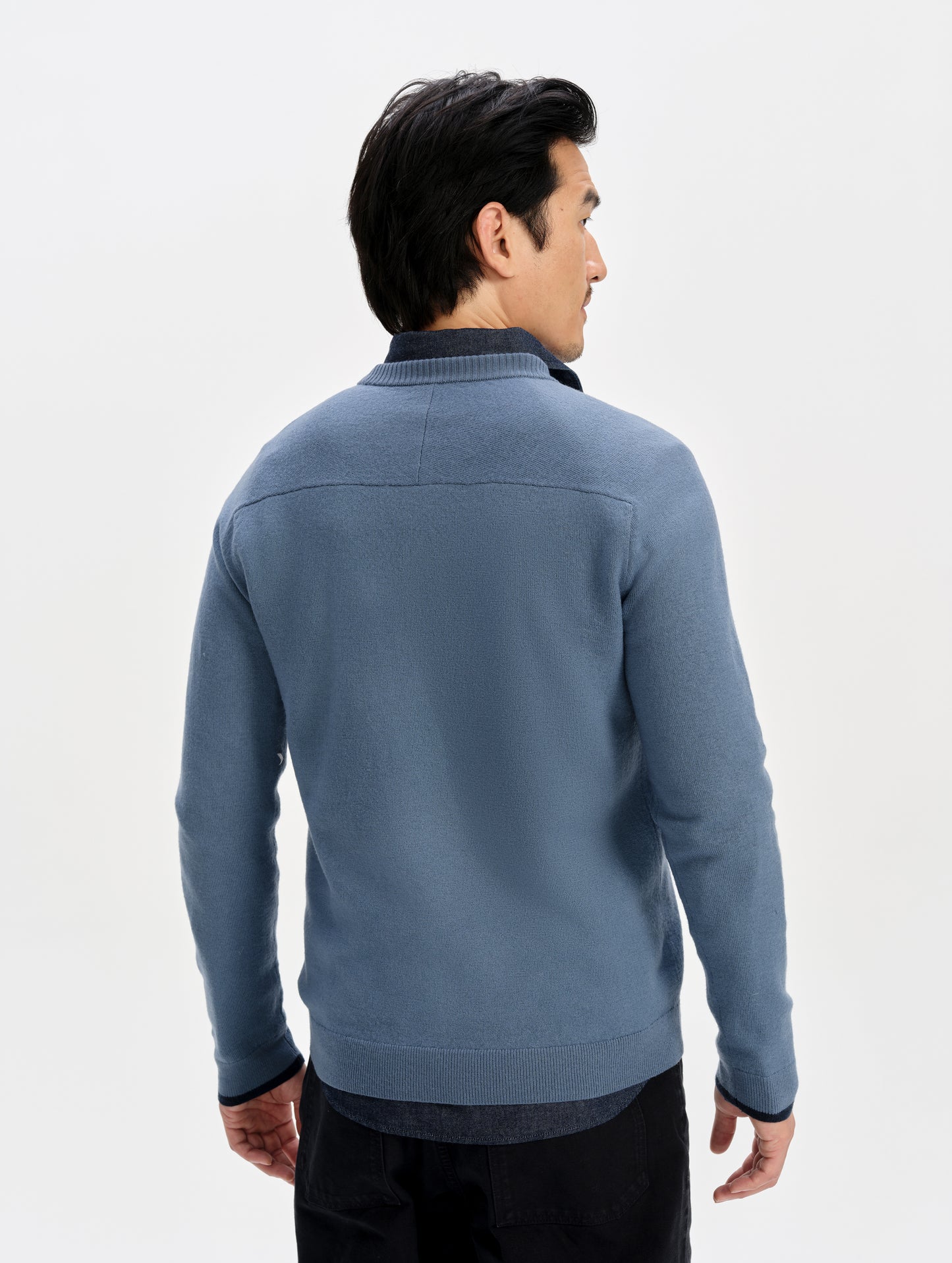 Rear upper-body view of man wearing the Corbin Sweater in Portal Blue from AETHER Apparel.