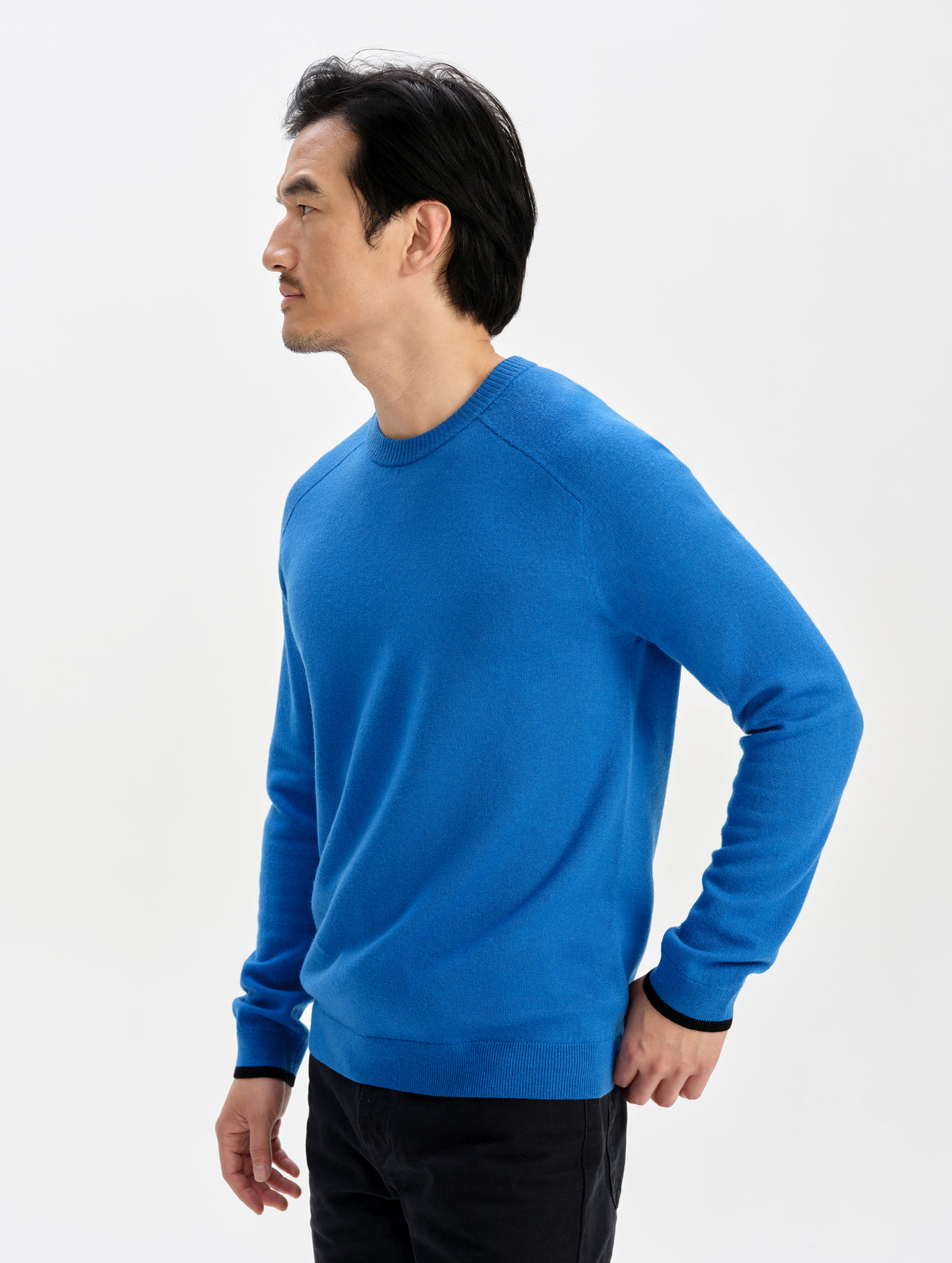 Front 3/4 upper-body view of man wearing the Corbin Sweater in Summit Blue from AETHER Apparel.