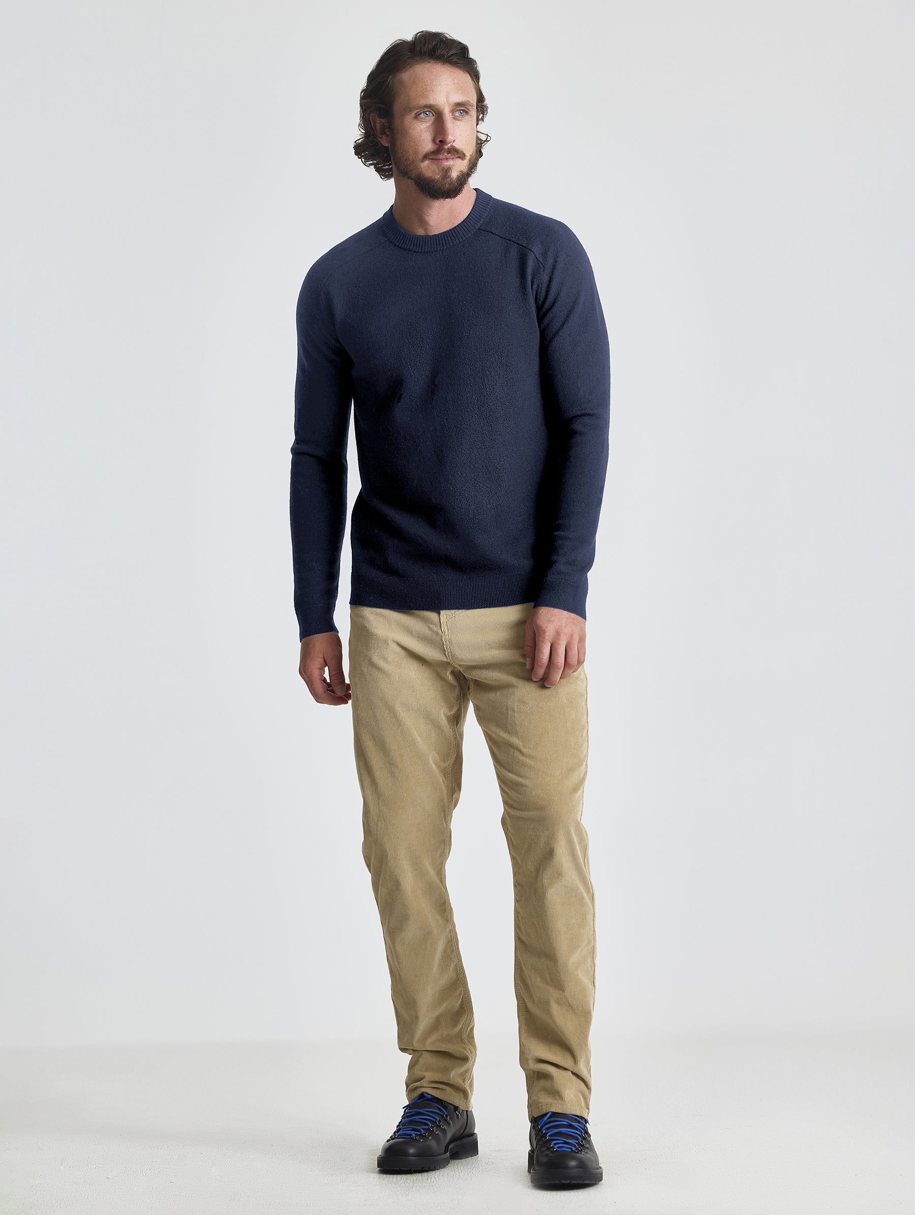 Full body view of man wearing Corbin Sweater in Total Eclipse dark blue from AETHER Apparel.