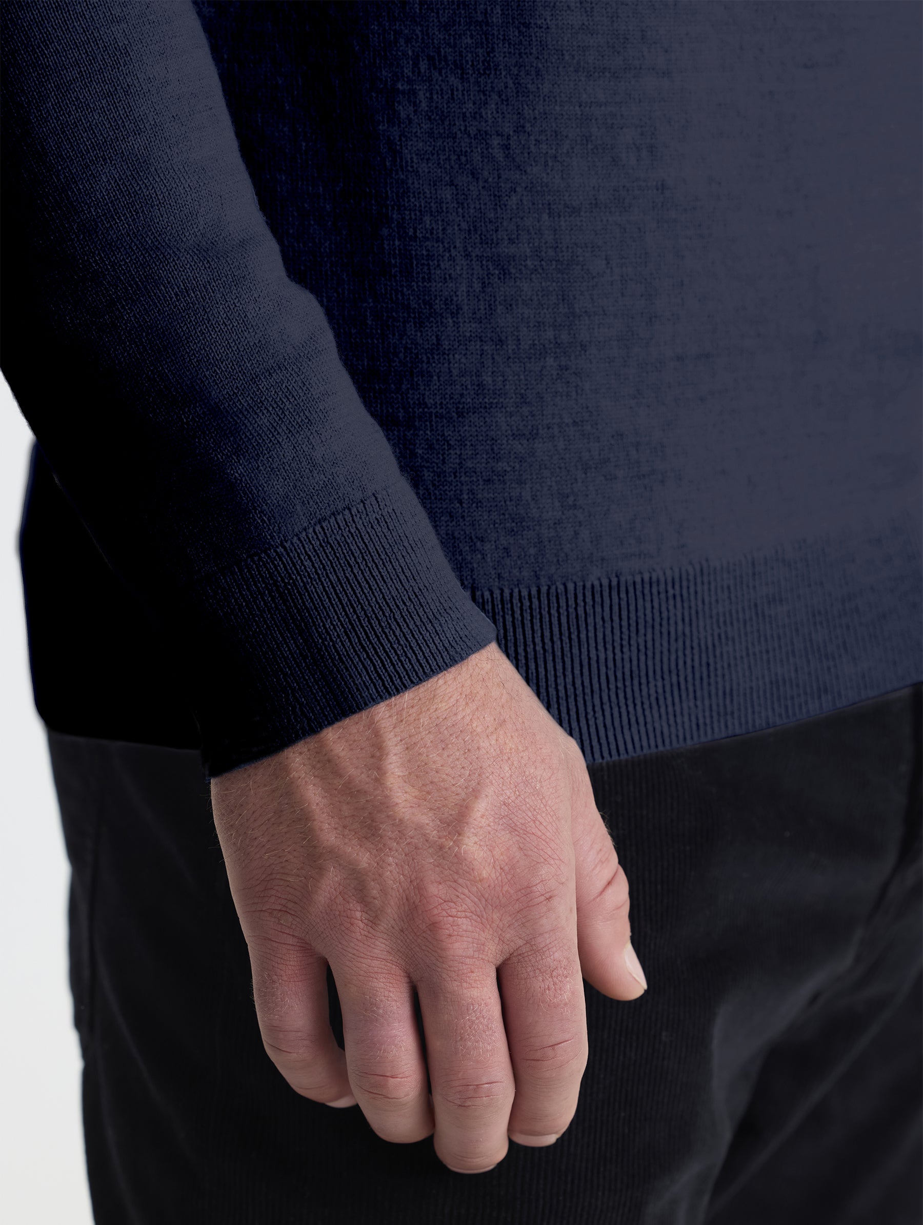 Closeup detail view of wearer's right sleeve of Corbin Sweater in Total Eclipse dark blue from AETHER Apparel.