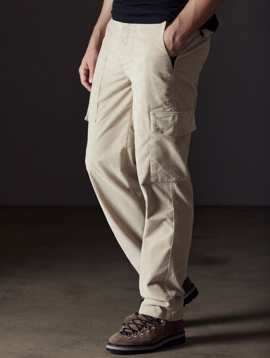 Front angled lower body view of man walking wearing Corduroy Fatigue Pant in Bone white from AETHER Apparel.