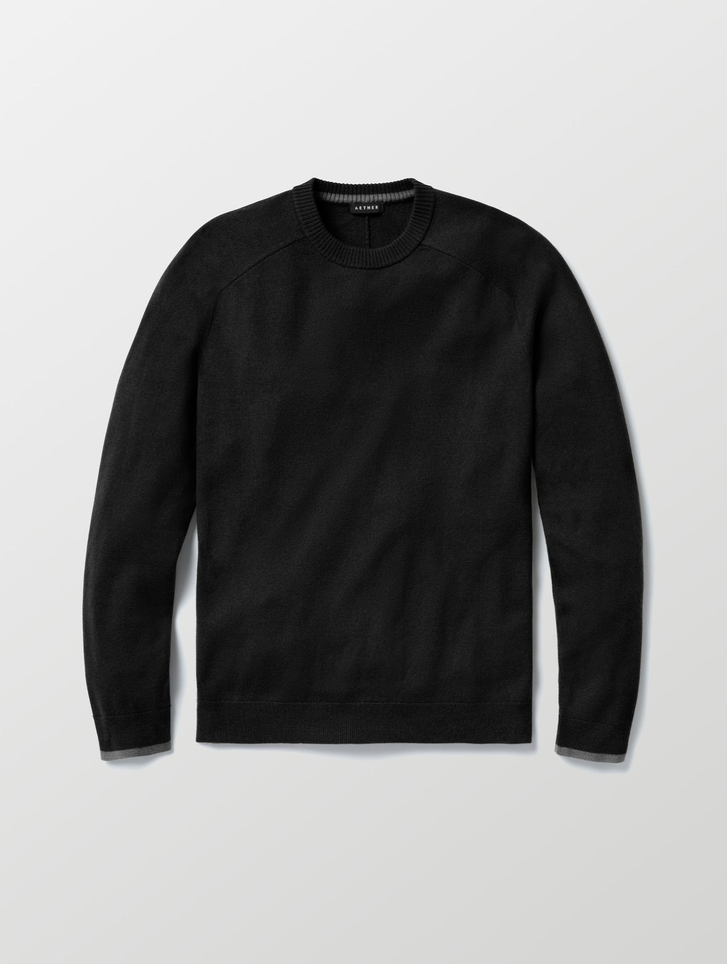 Flat lay of Corbin Sweater in Onyx Black from AETHER Apparel. 