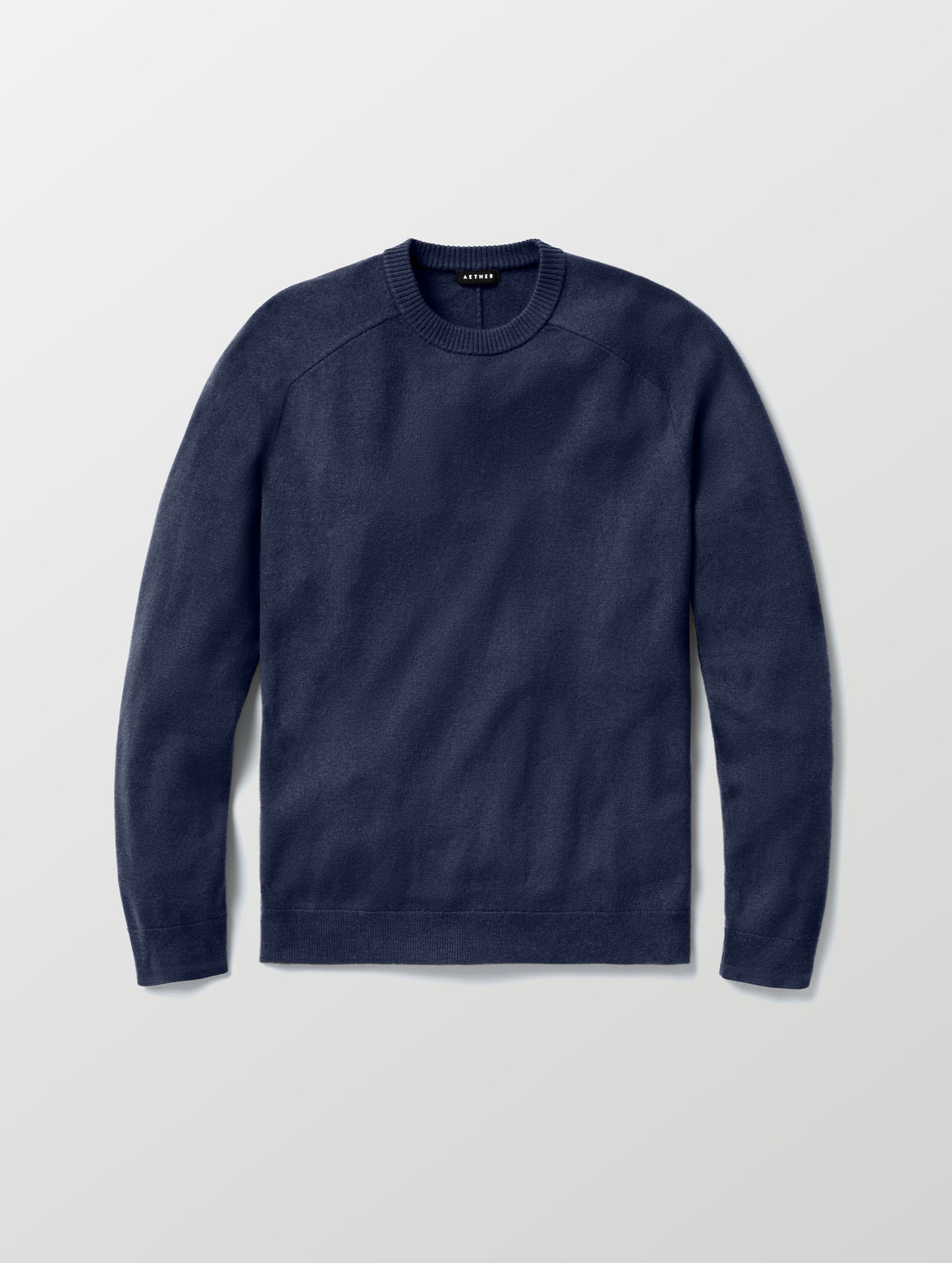 Flat lay of Corbin Sweater in Total Eclipse dark blue from AETHER Apparel. 