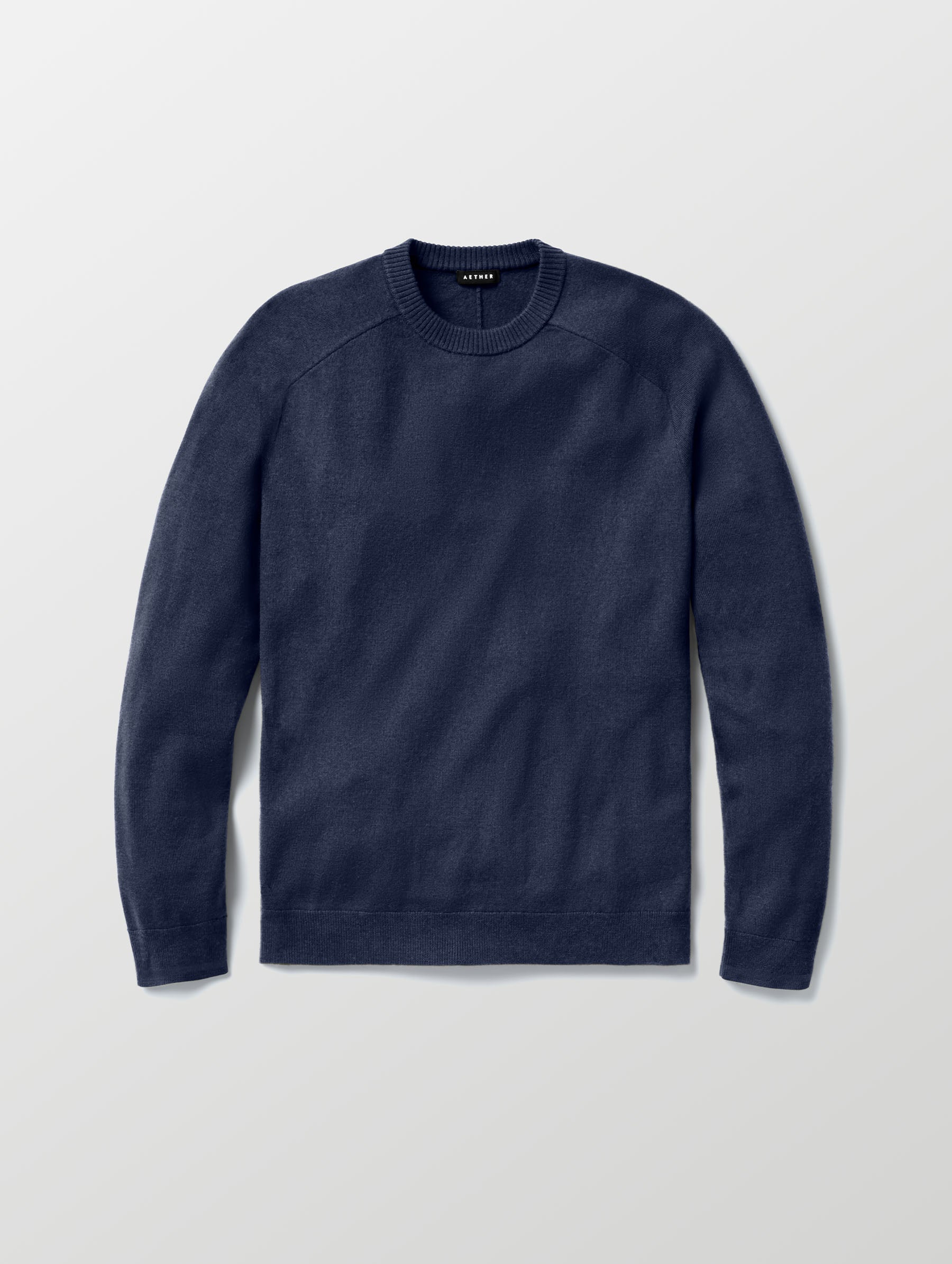 Flat lay of Corbin Sweater in Total Eclipse dark blue from AETHER Apparel. 