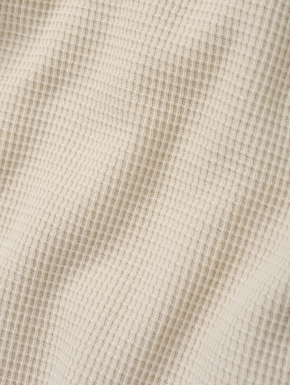 Closeup detailed view of the cotton double-weave waffle fabric on the Daley Waffle Henley in Bone from AETHER Apparel.