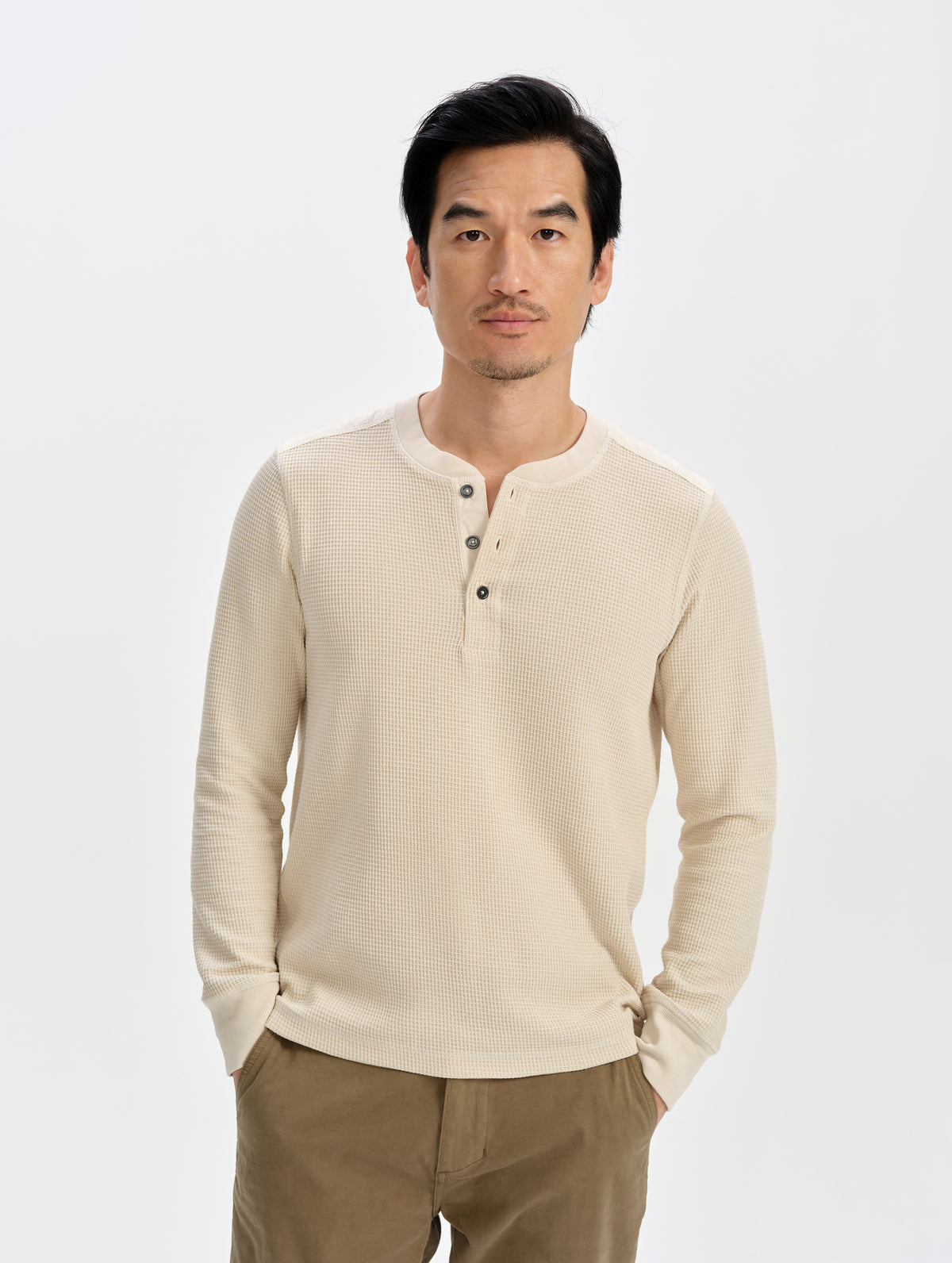 Front upper-body view of man wearing the Daley Waffle Henley in Bone from AETHER Apparel.