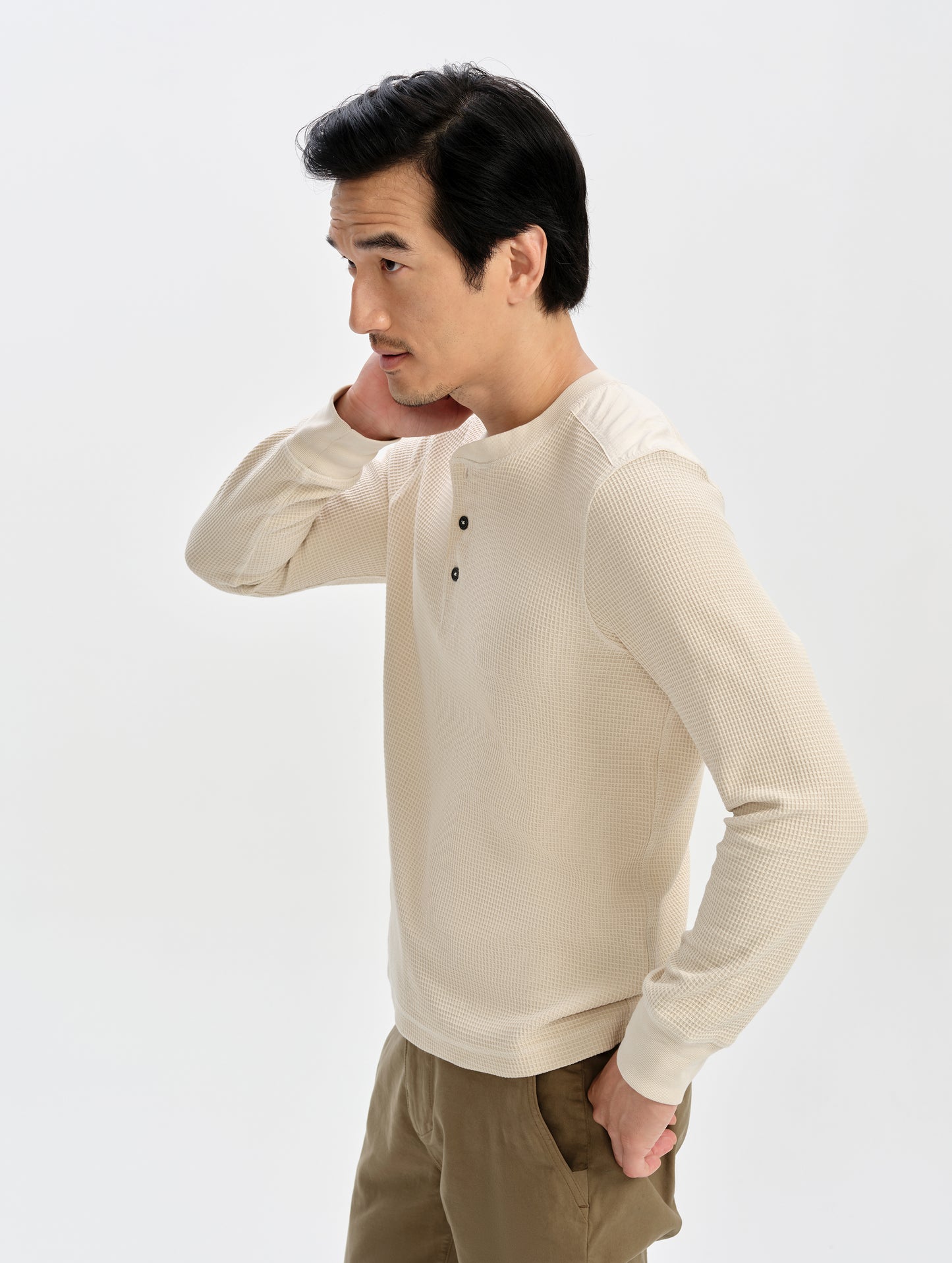 Front 3/4 upper-body view of man wearing the Daley Waffle Henley in Bone from AETHER Apparel.