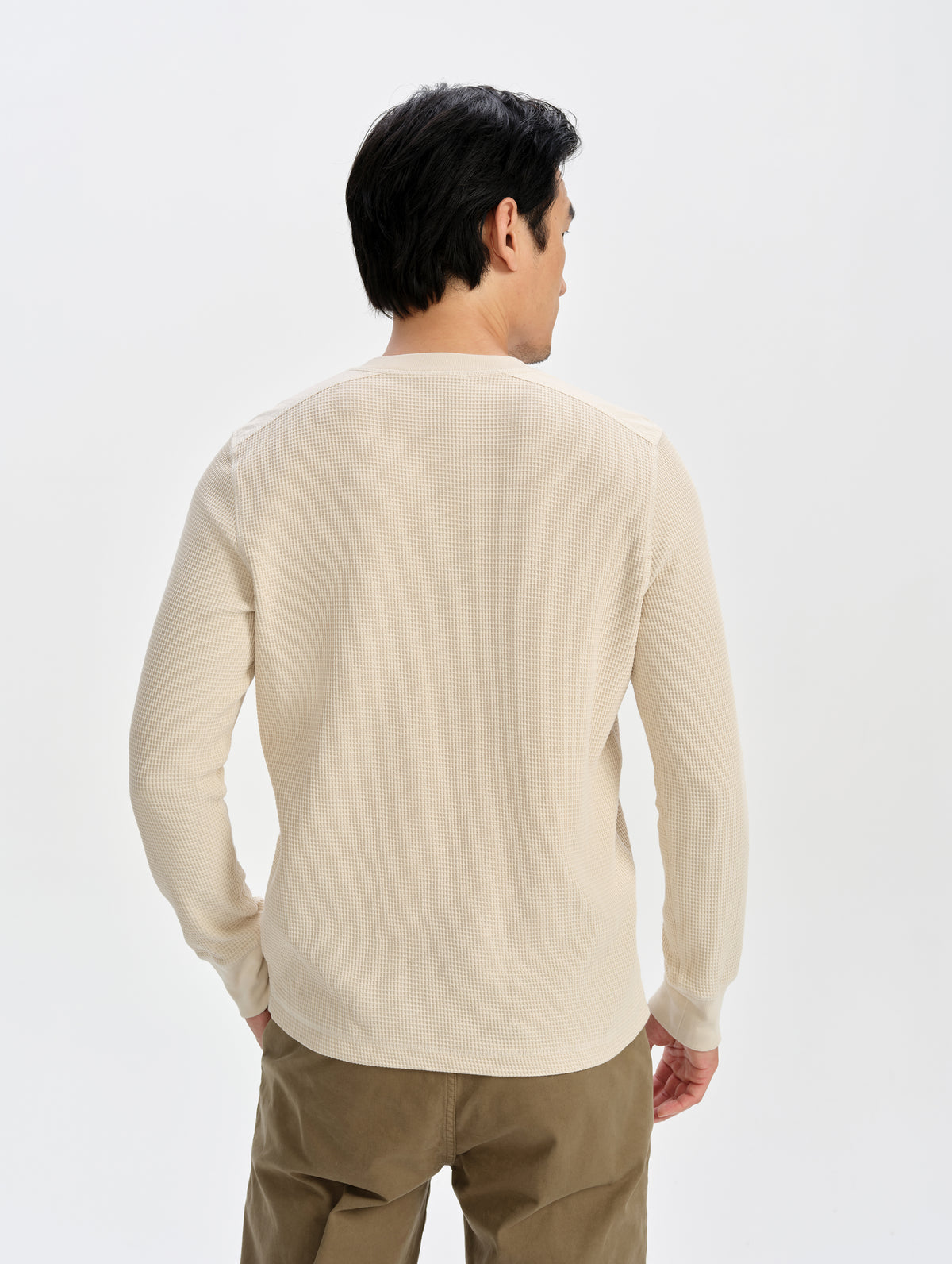 Rear upper-body view of man wearing the Daley Waffle Henley in Bone from AETHER Apparel.
