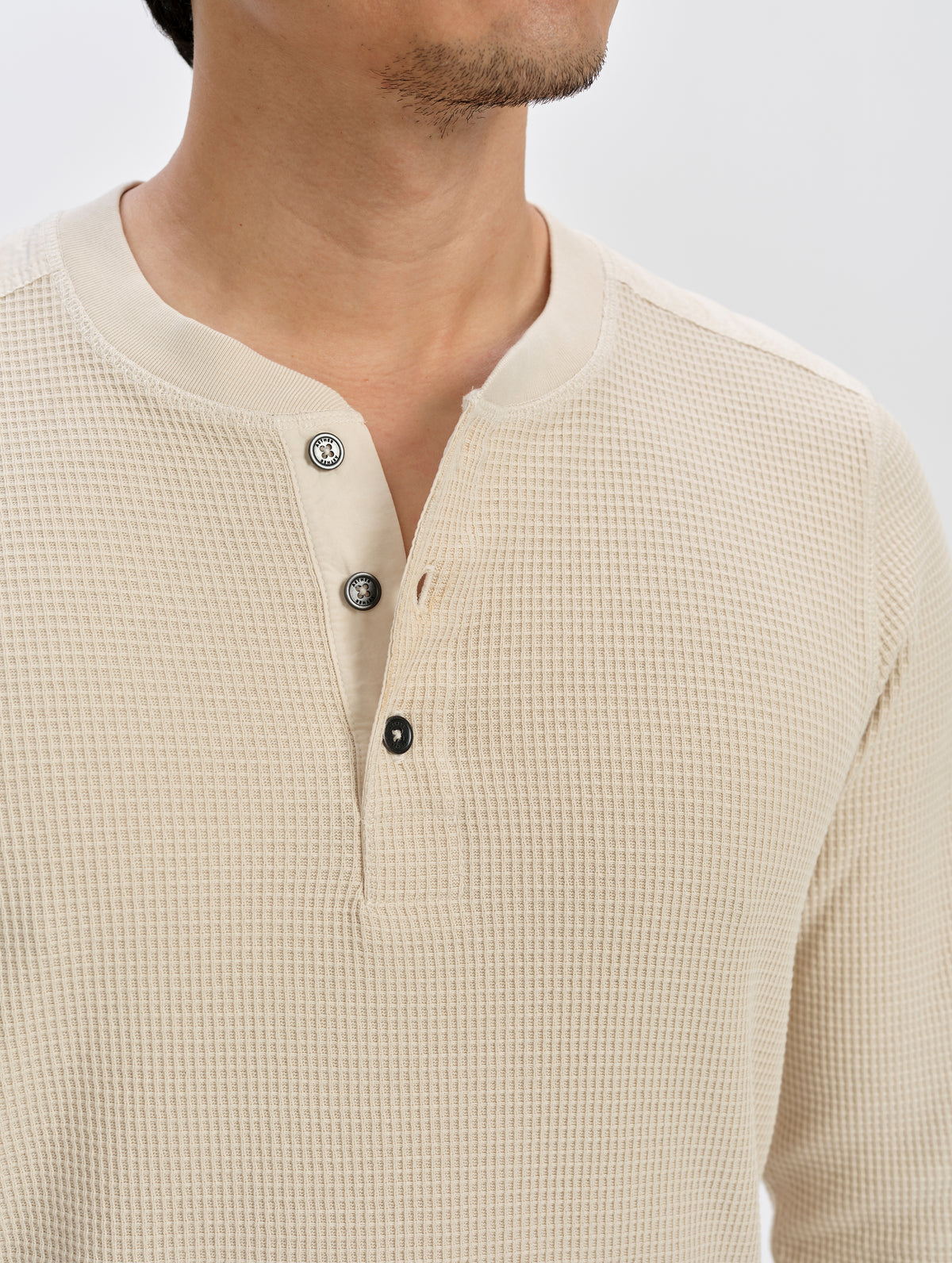 Closeup detailed view of the henley buttons on the Daley Waffle Henley in Bone from AETHER Apparel.