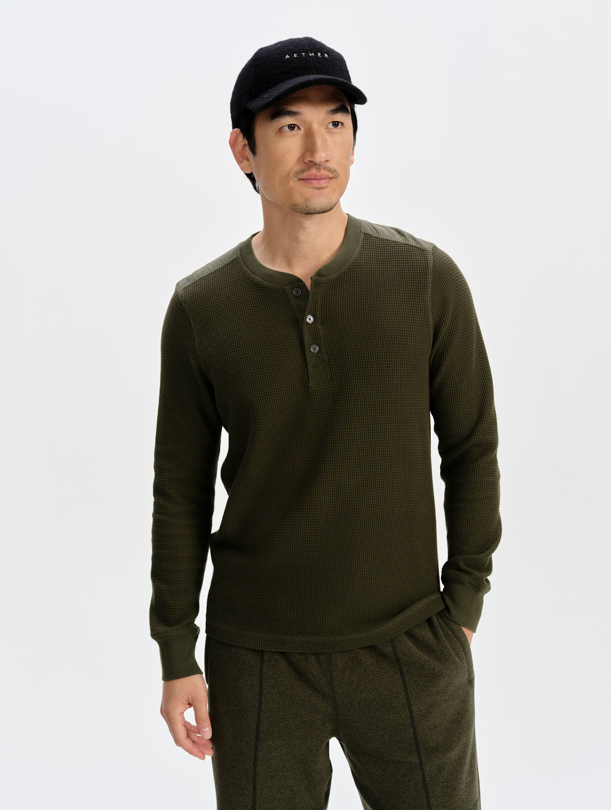 Front upper-body view of man wearing the Daley Waffle Henley in Forest Green from AETHER Apparel.