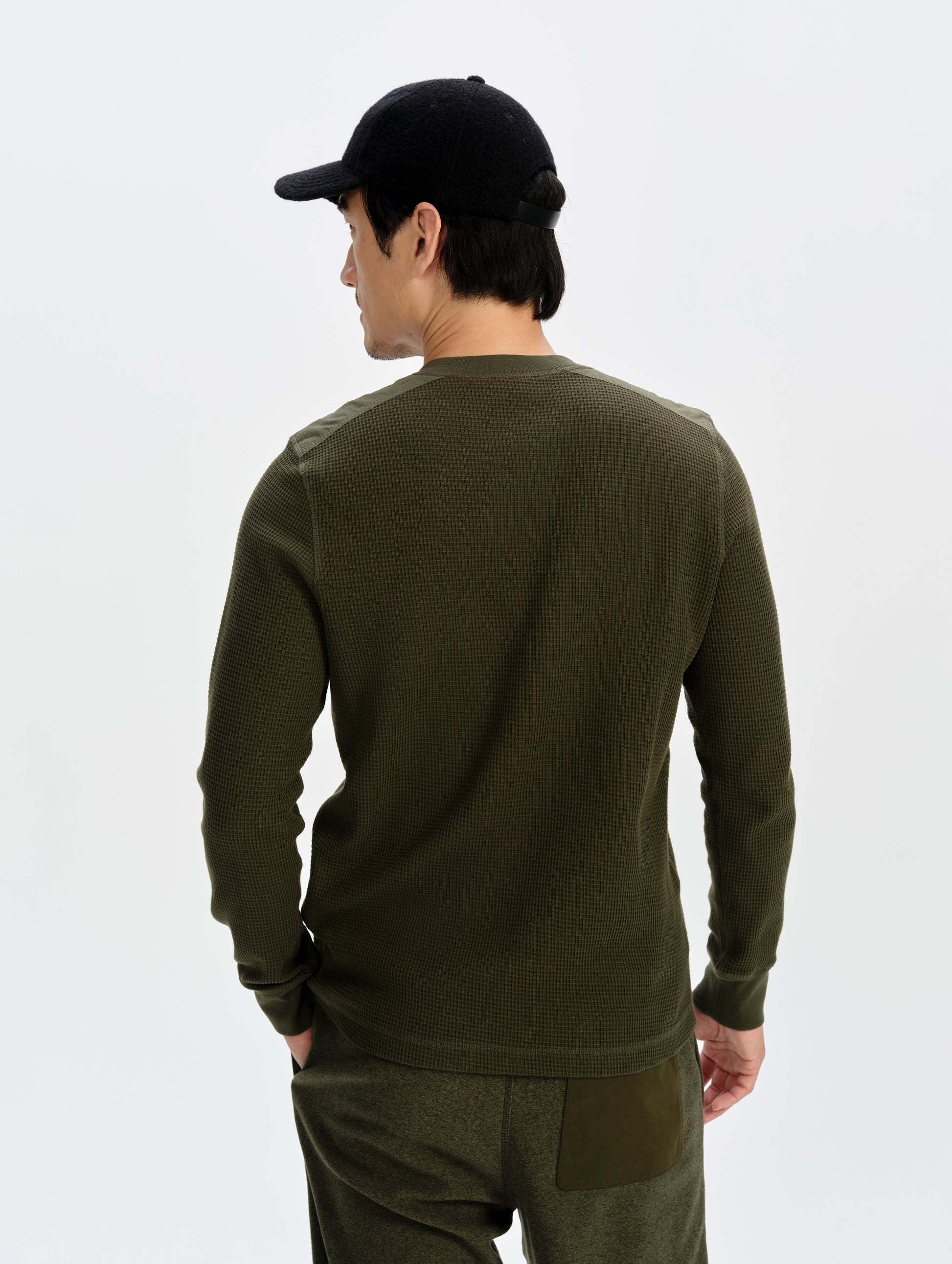 Rear upper-body view of man wearing the Daley Waffle Henley in Forest Green from AETHER Apparel.