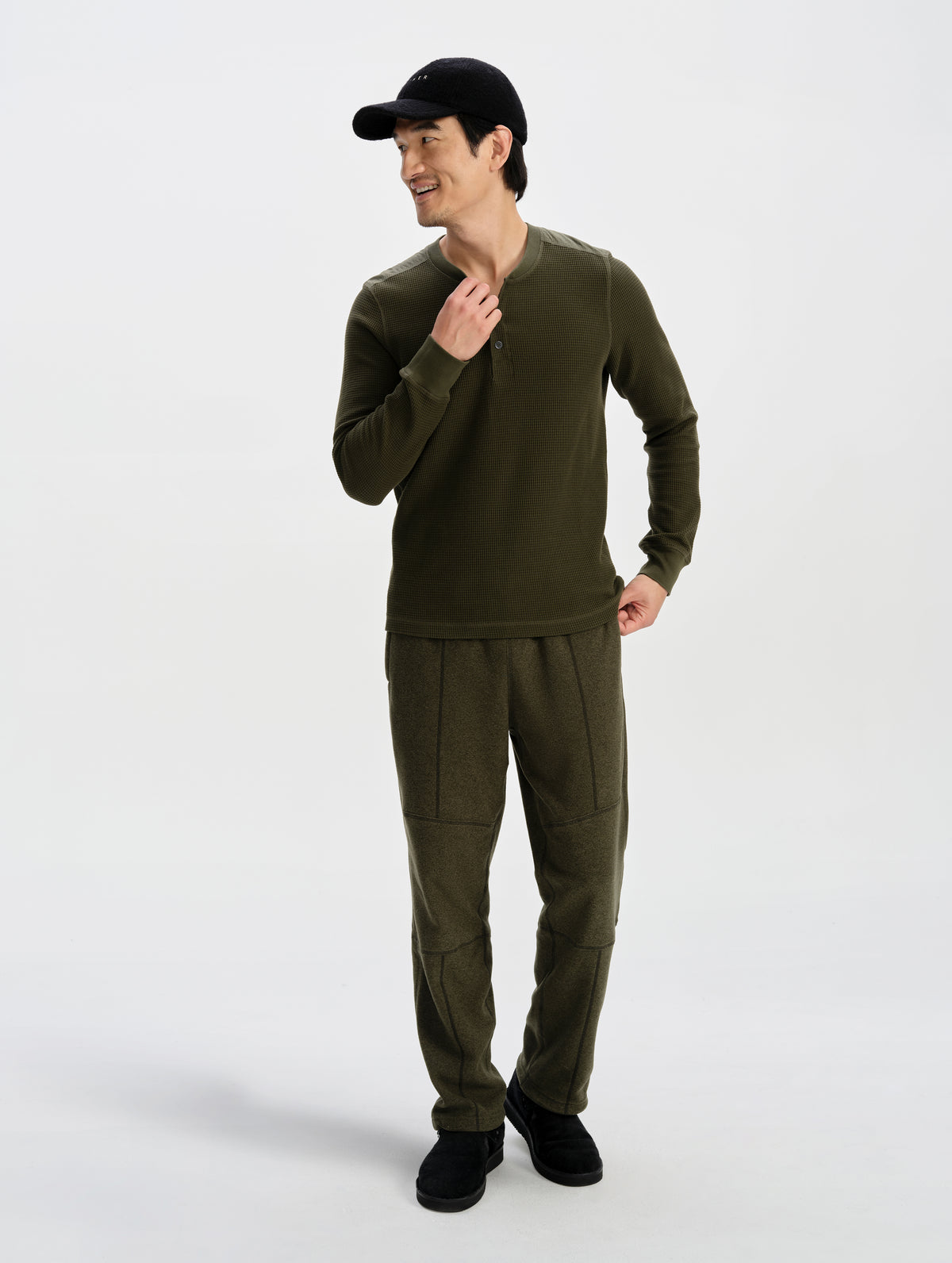 Front full-body view of man wearing the Daley Waffle Henley in Forest Green from AETHER Apparel.