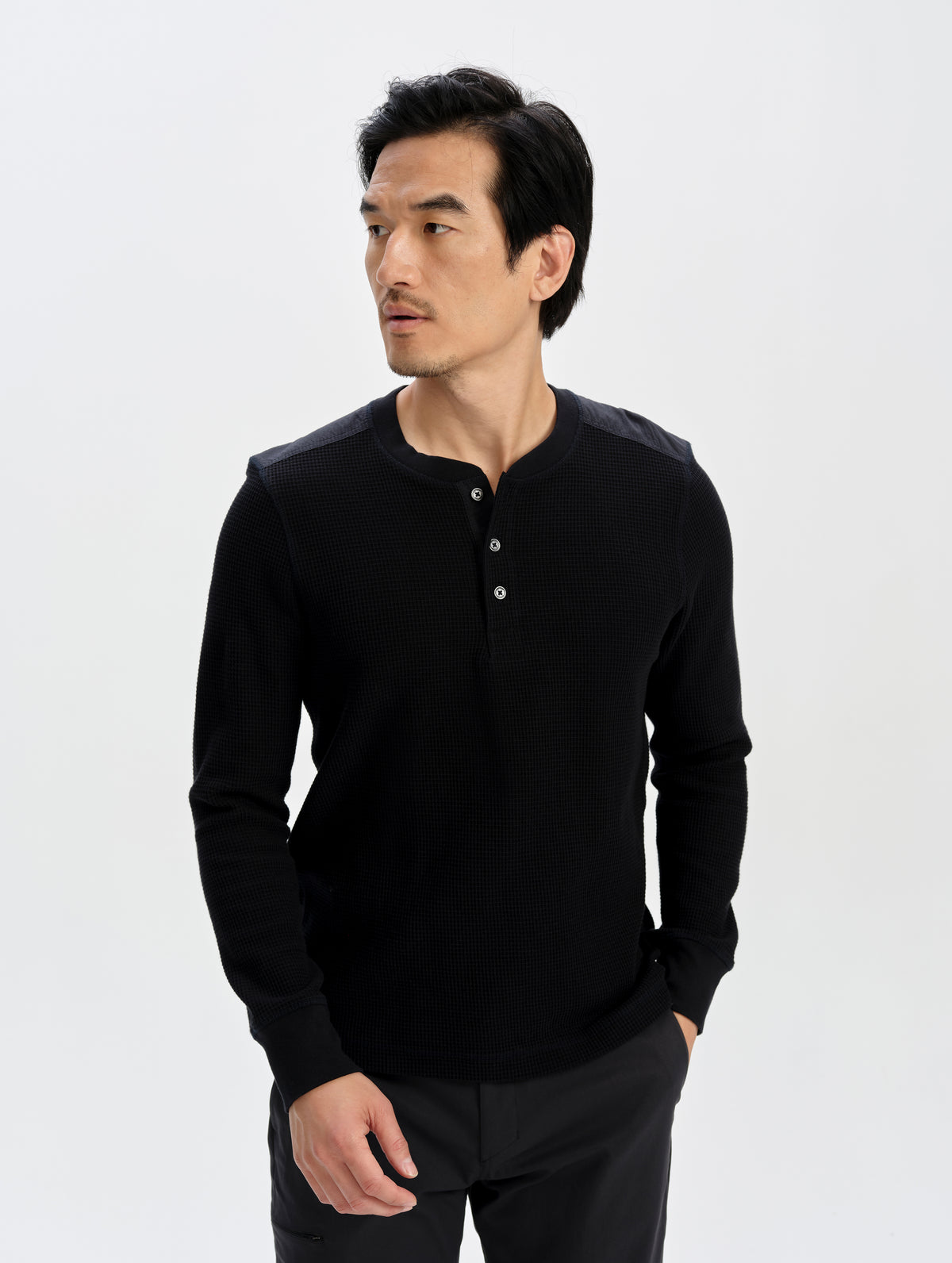 Front upper-body view of man wearing the Daley Waffle Henley in Onyx Black from AETHER Apparel.