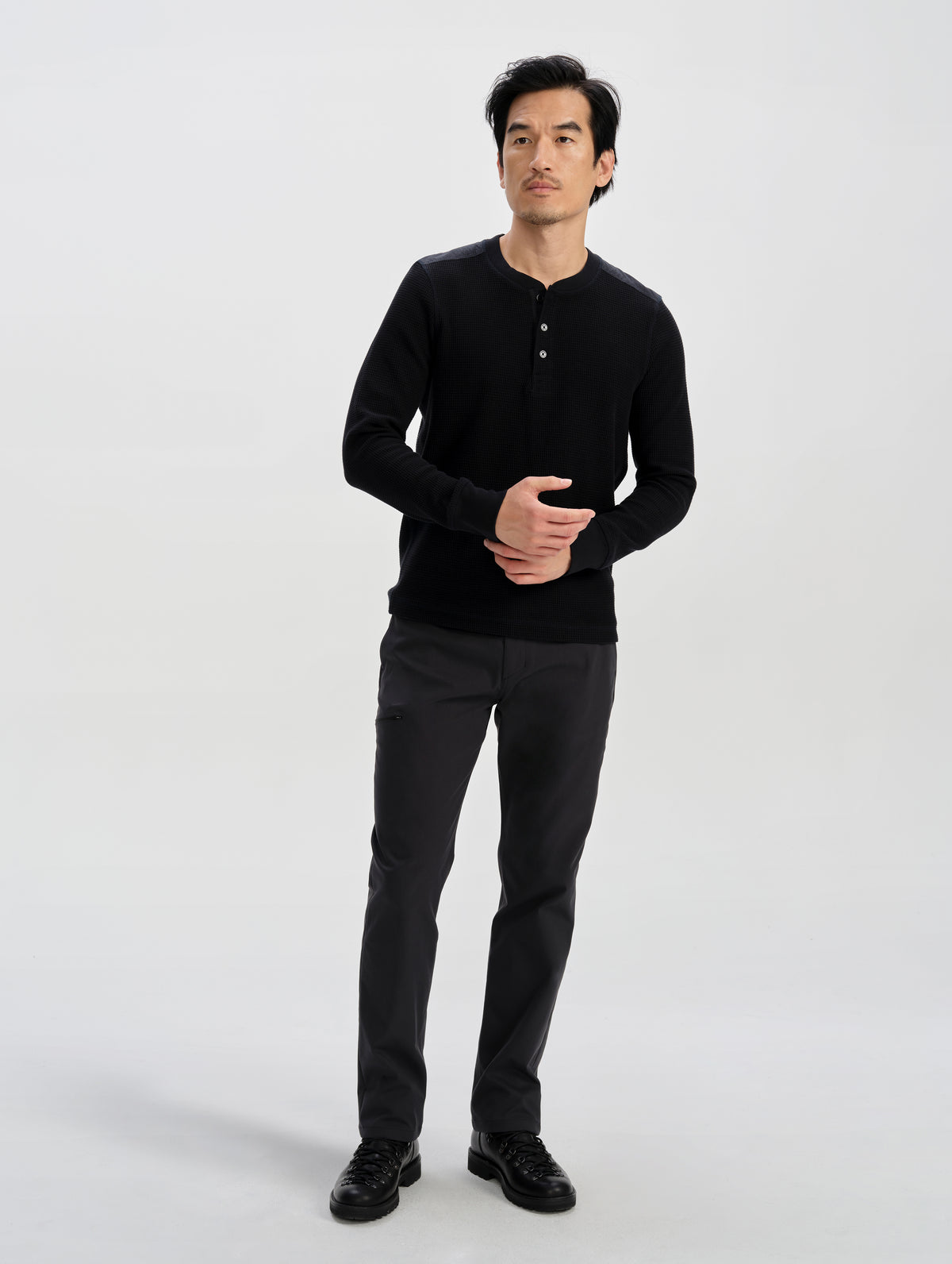 Front full-body view of man wearing the Daley Waffle Henley in Onyx Black from AETHER Apparel.