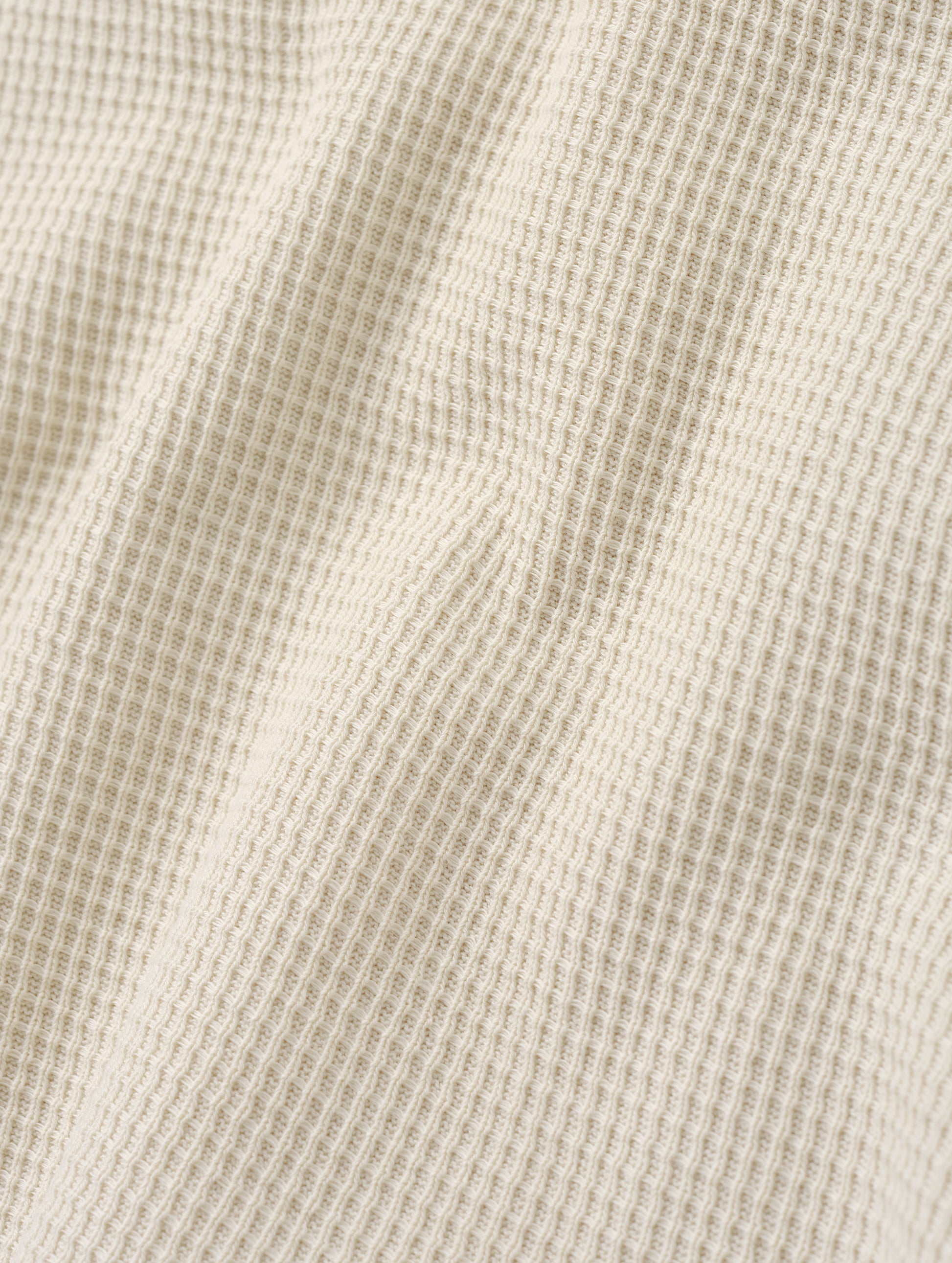 Closeup detailed view of the cotton double-weave waffle fabric on the Daley Waffle Shirt in Bone from AETHER Apparel.
