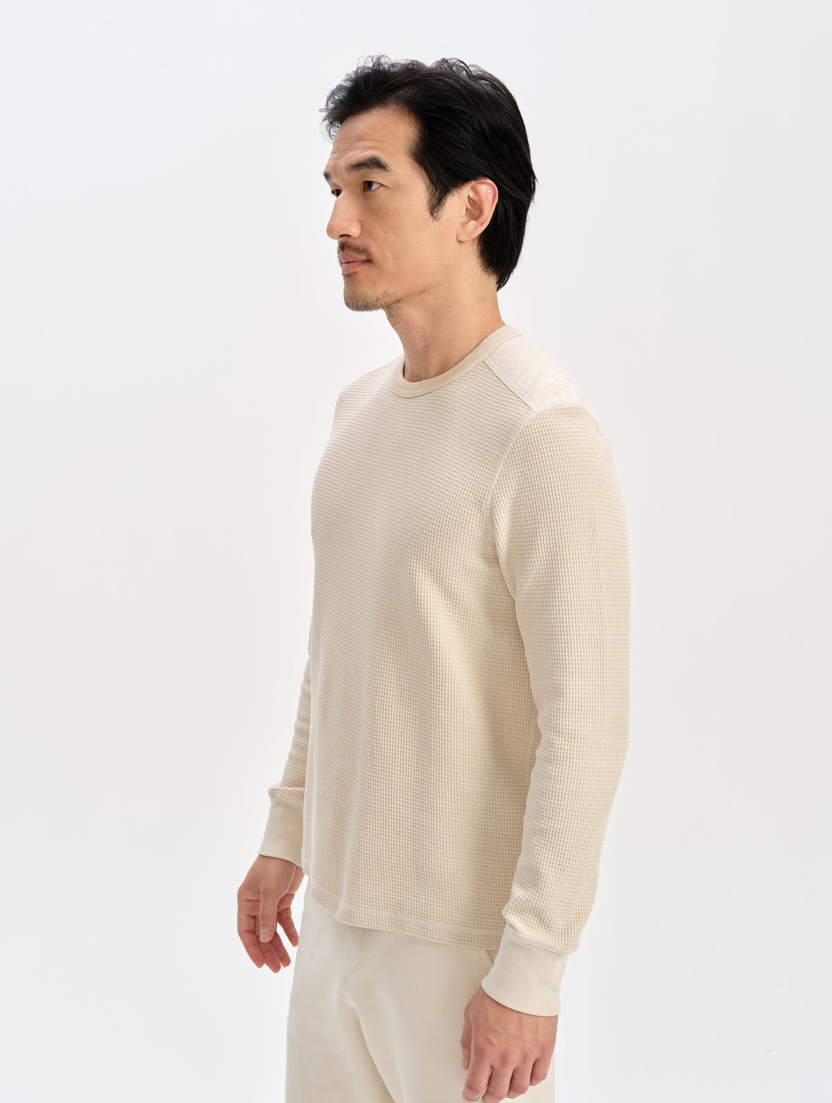 Front 3/4 upper-body view of man wearing the Daley Waffle Shirt in Bone from AETHER Apparel.