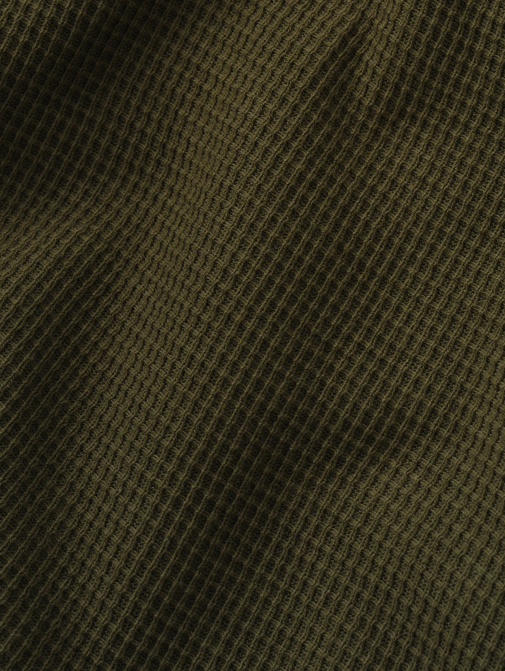 Closeup detailed view of the cotton double-weave waffle fabric on the Daley Waffle Shirt in Forest Green from AETHER Apparel.