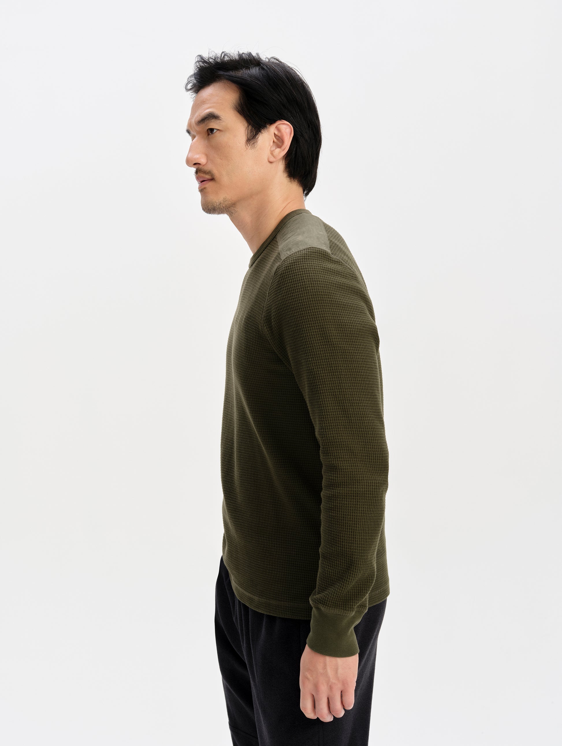 Side profile upper-body view of man wearing the Daley Waffle Shirt in Forest Green from AETHER Apparel.