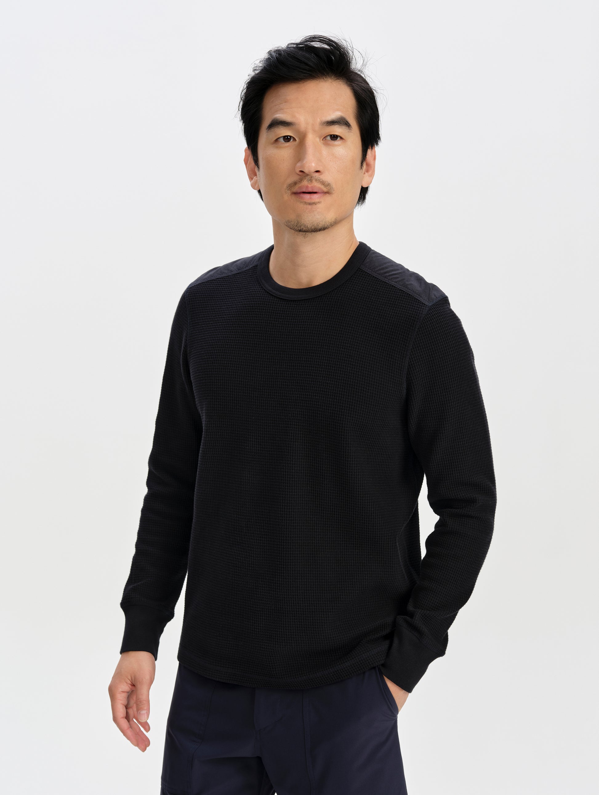 Front upper-body view of man wearing the Daley Waffle Shirt in Onyx Black from AETHER Apparel.