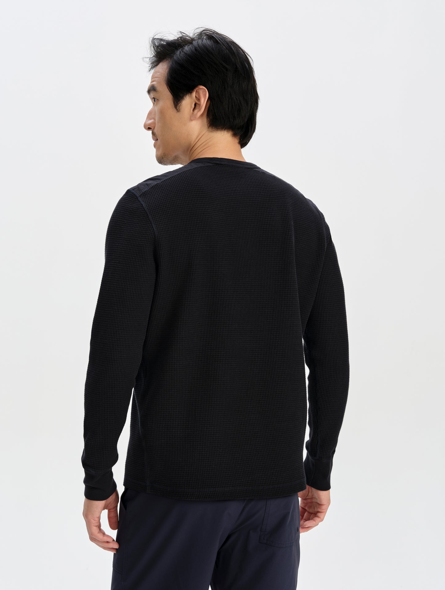 Rear upper-body view of man wearing the Daley Waffle Shirt in Onyx Black from AETHER Apparel.