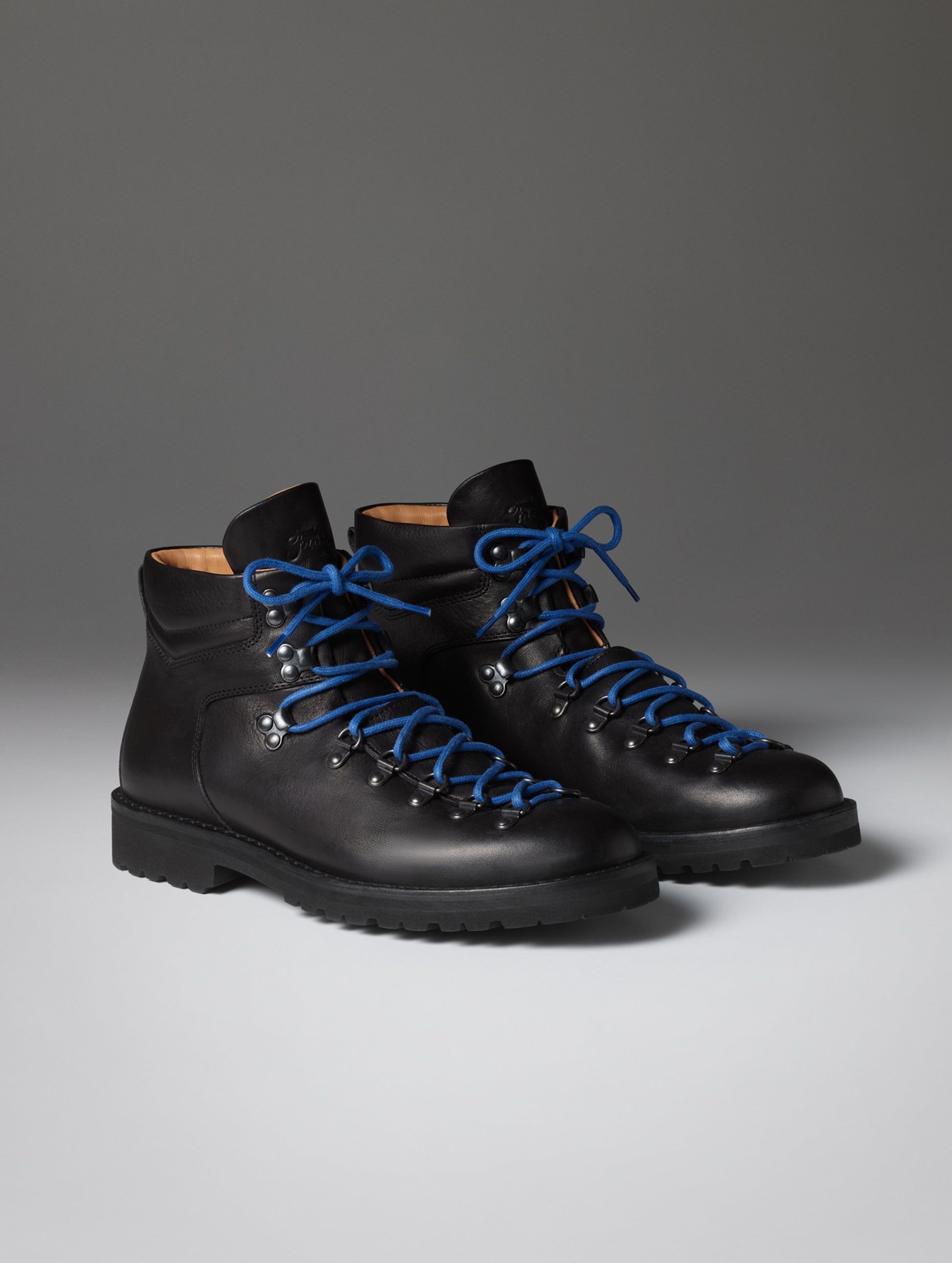 Front angled view of the men's Dolomite Boot in Onyx Black with blue laces from AETHER Apparel.