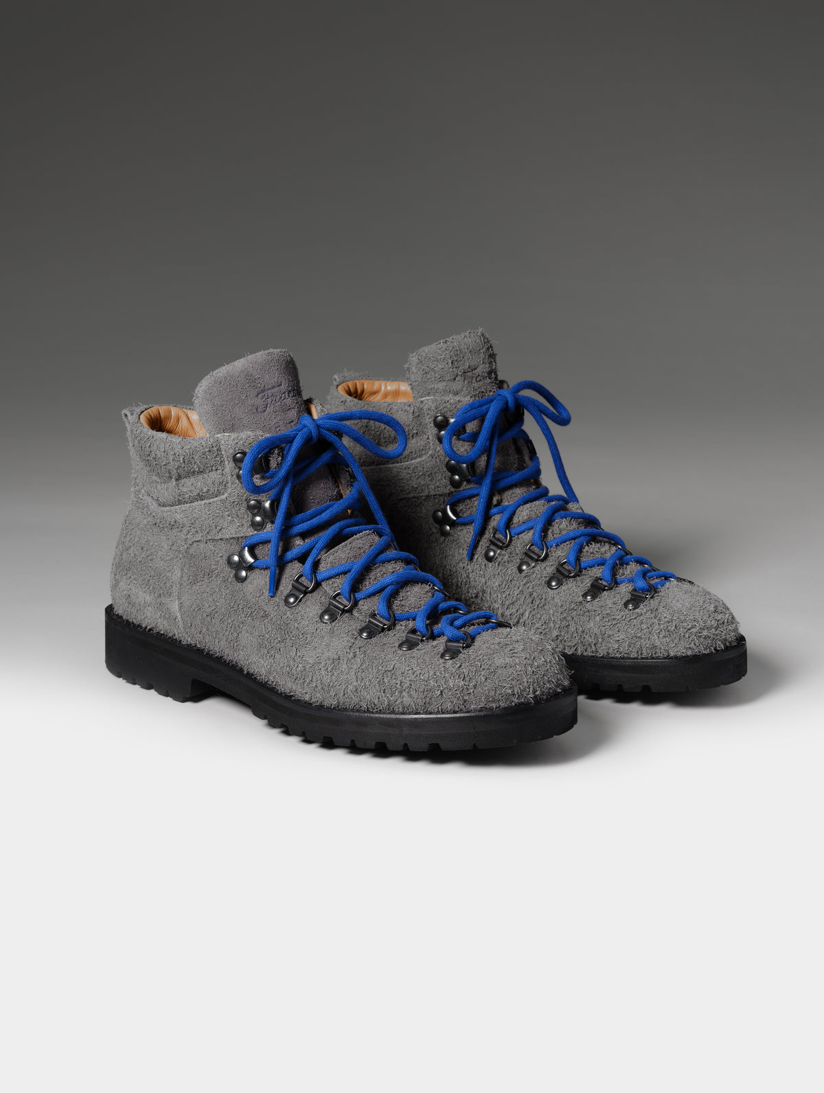 Front 3/4 studio shot of the Dolomite Boot in Cement with blue laces from AETHER Apparel.