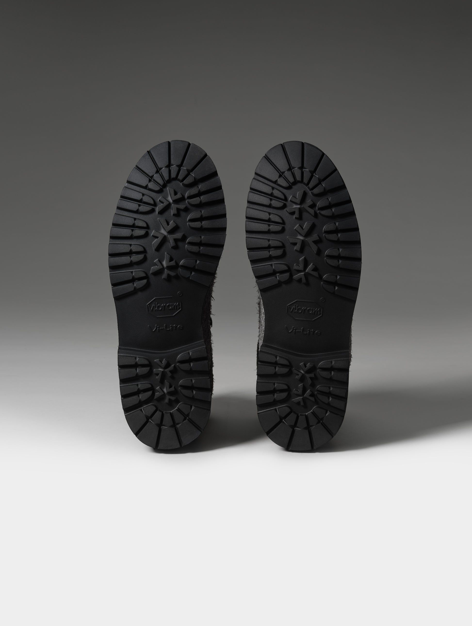 Studio shot of the Vibram outsoles on the Dolomite Boot in Cement  from AETHER Apparel.