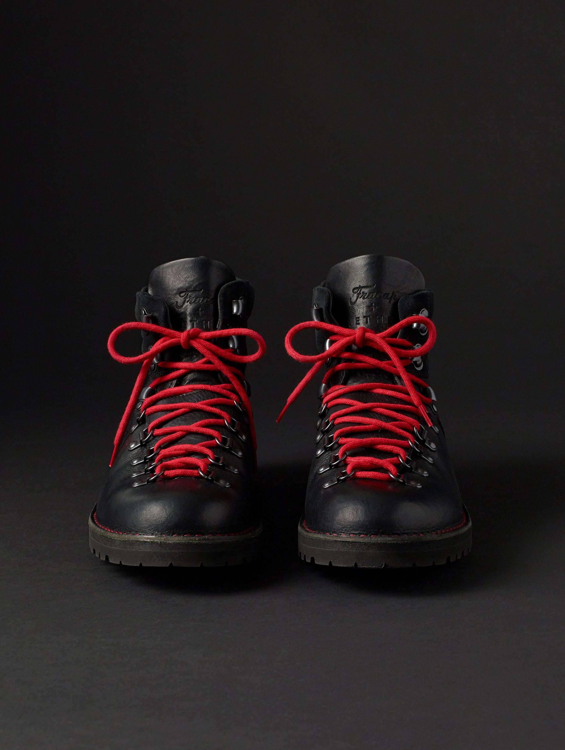 Front view of the men's Dolomite Boot in Onyx Black with red laces from AETHER Apparel.
