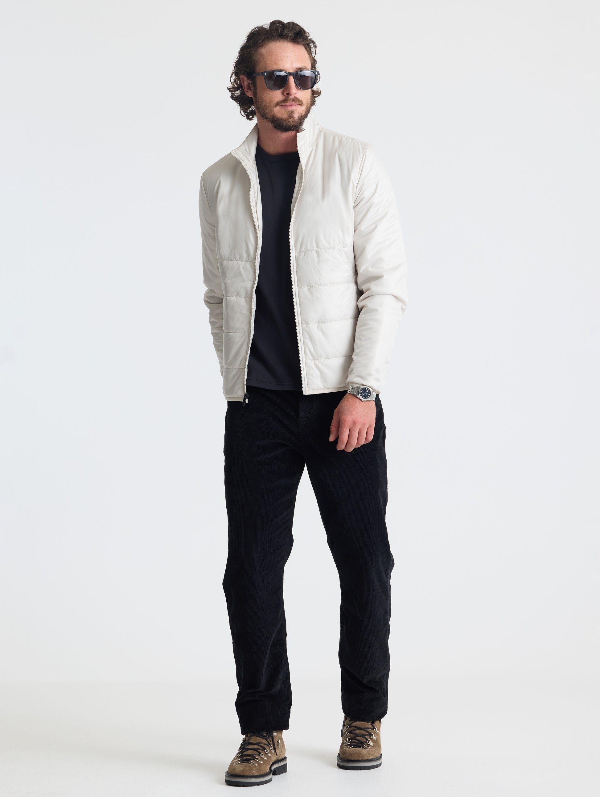 Full body view of man wearing Eco Insulated Jacket in Bone white from AETHER Apparel.