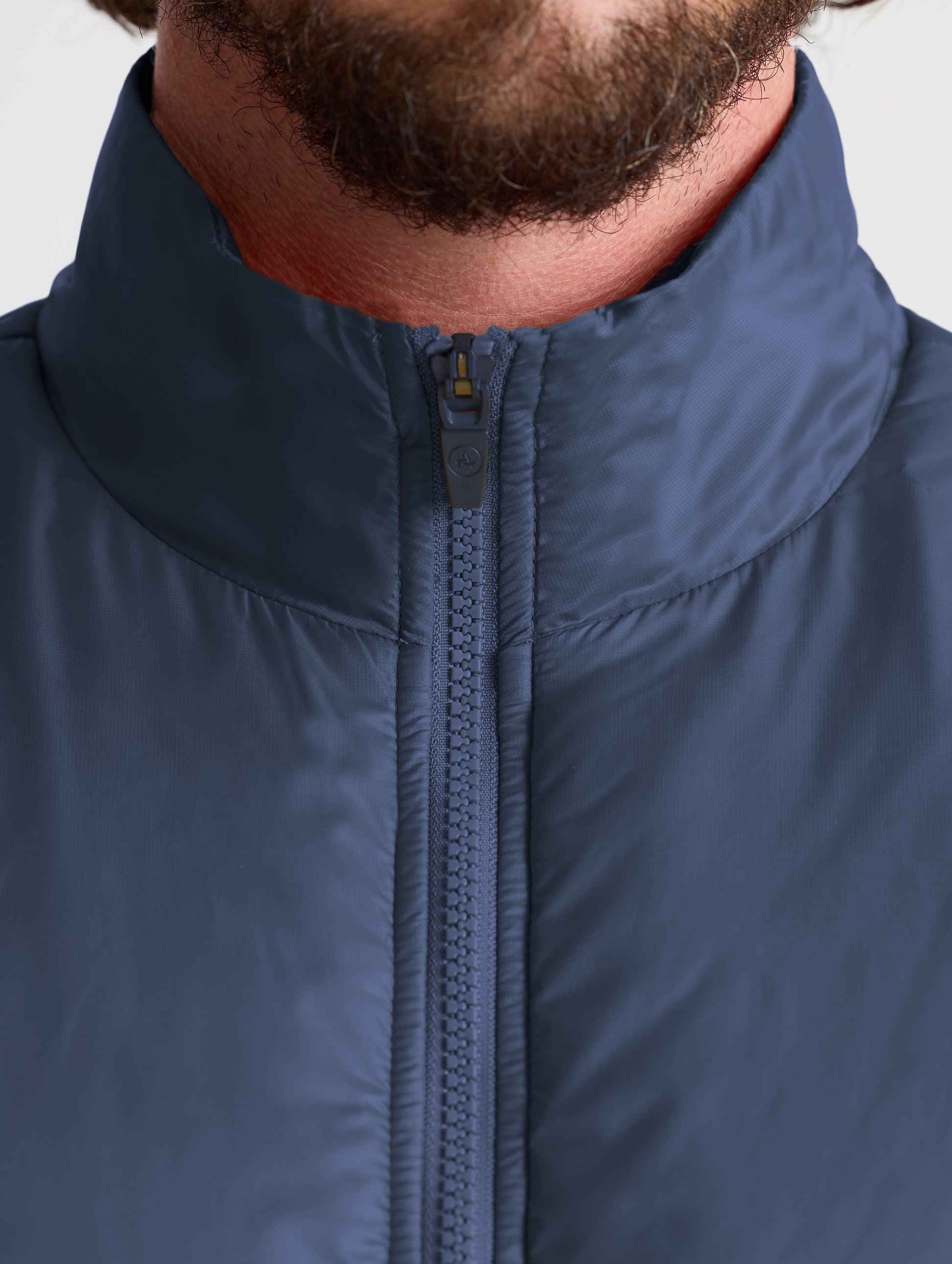 Closeup view of collar of Eco Insulated Jacket in Total Eclipse dark blue from AETHER Apparel.
