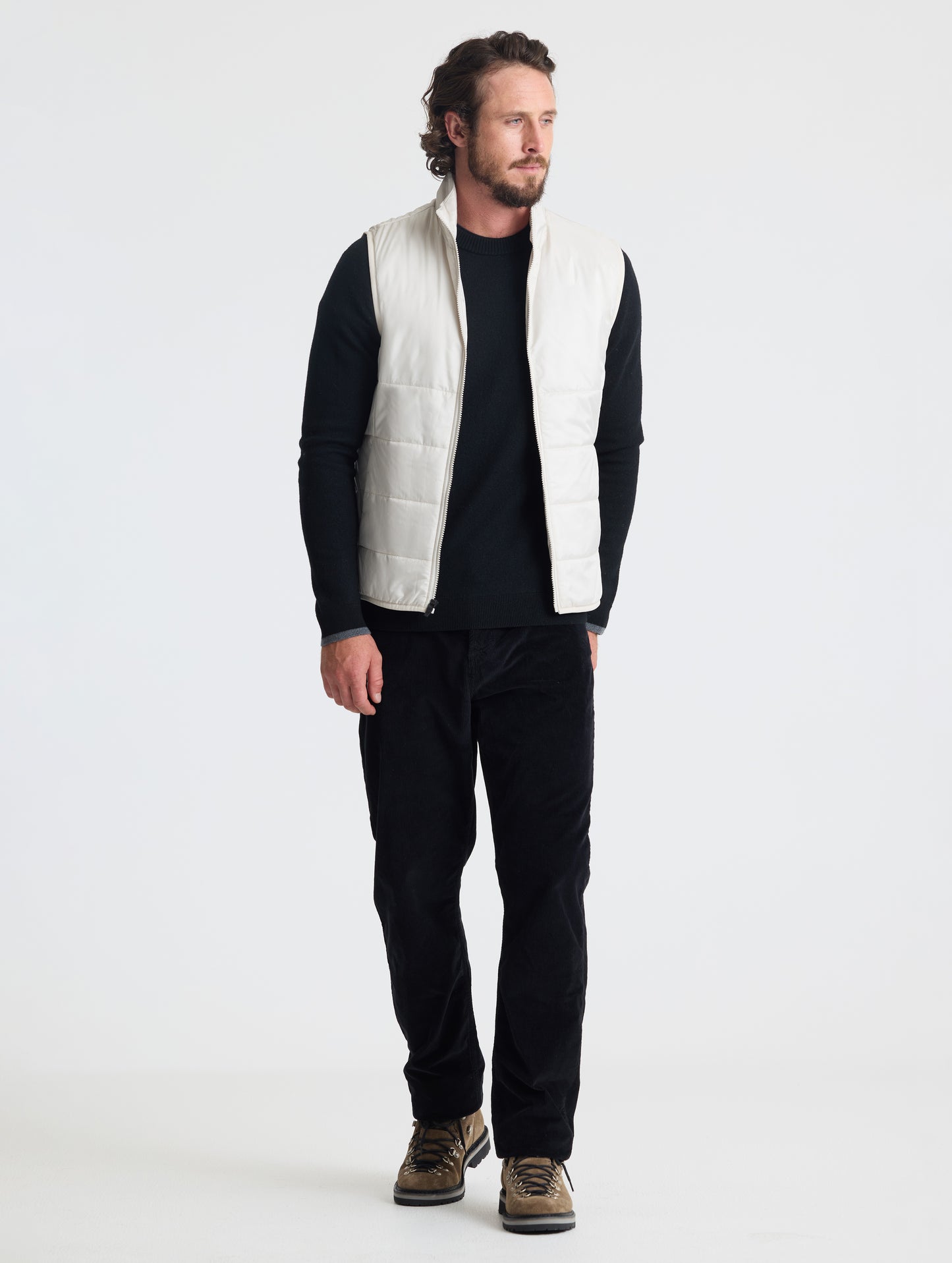 Full body view of man wearing Eco Insulated Vest in Bone white from AETHER Apparel.