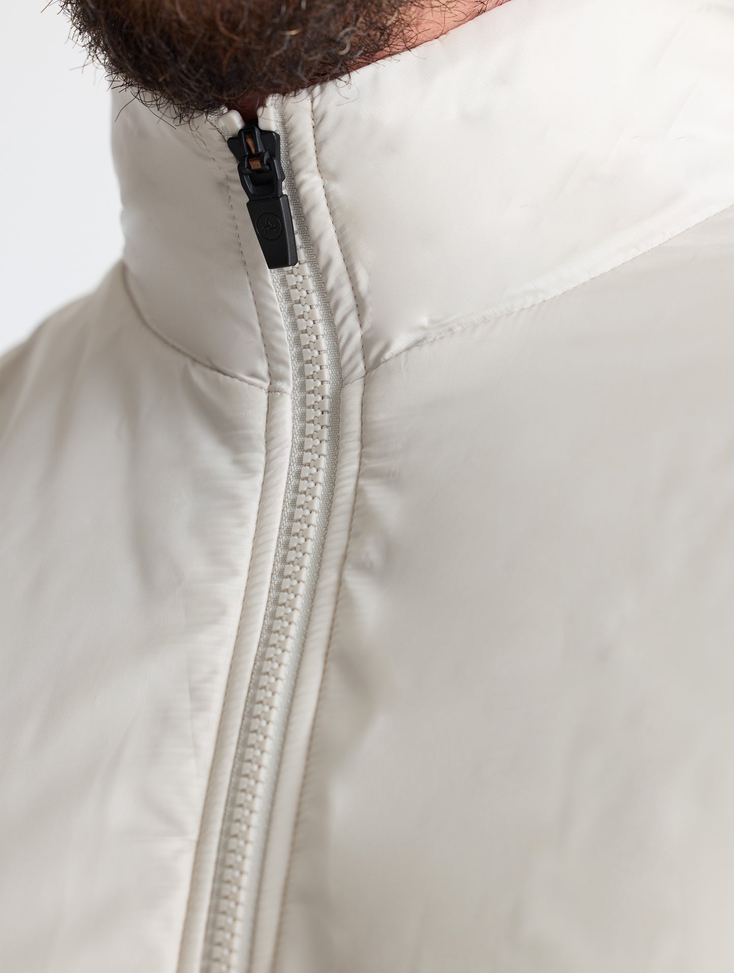 Closeup view of collar of Eco Insulated Vest in Bone white from AETHER Apparel.