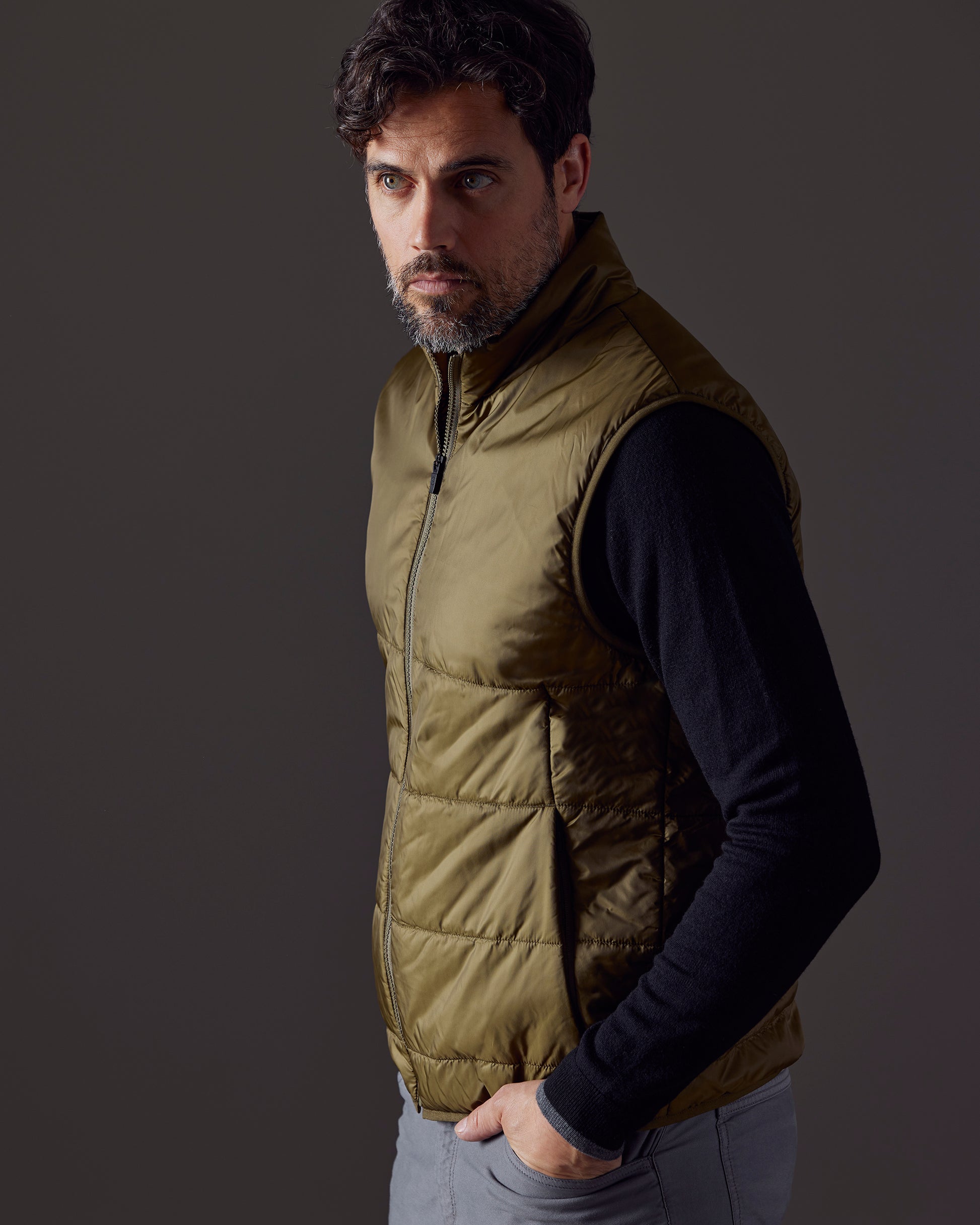 Man wearing green Eco Insulated Vest from AETHER Apparel