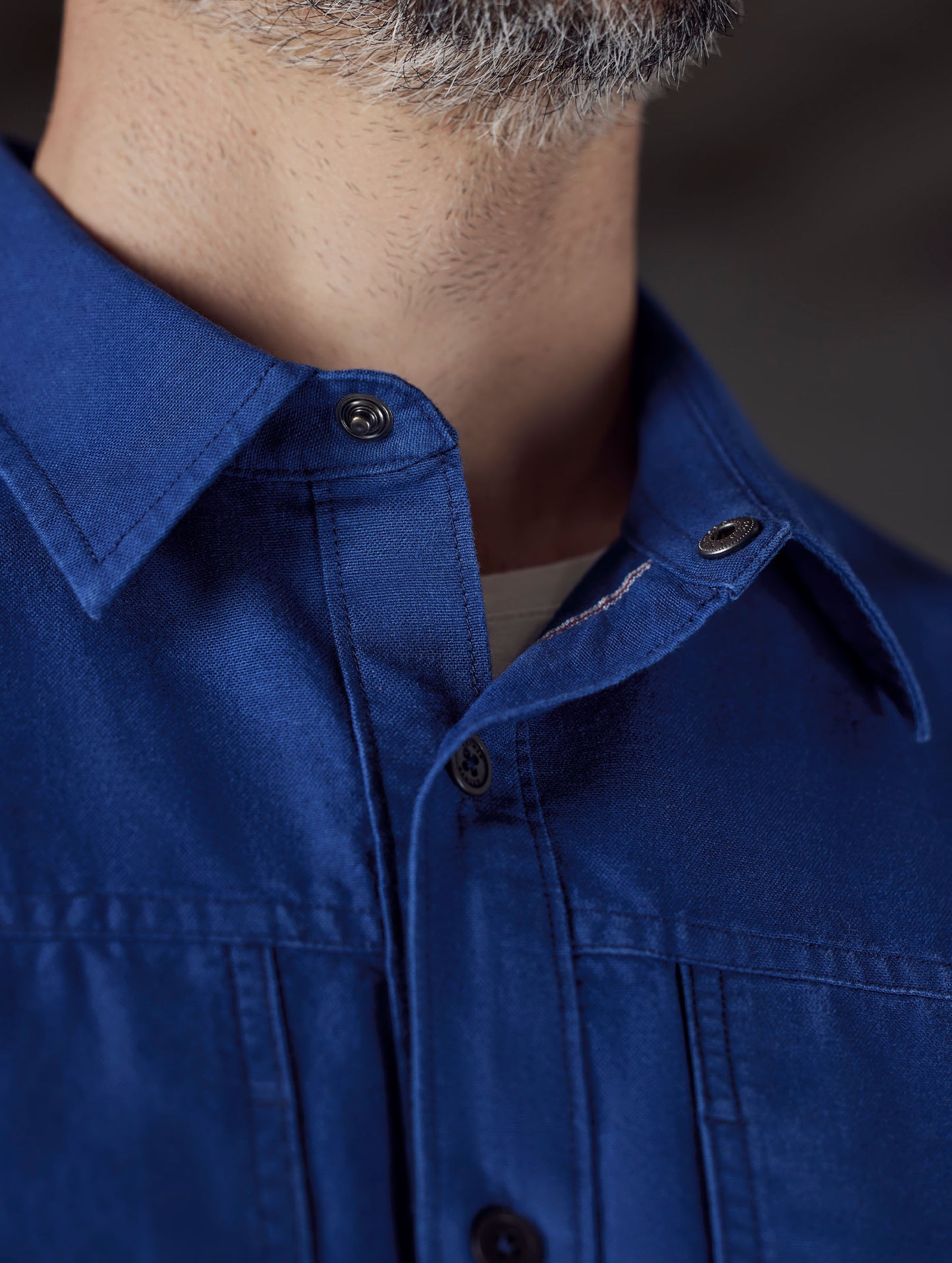 Closeup detailed view of the custom snap-secured collar on the Emerson Button Down in Dark Blue from AETHER Apparel.