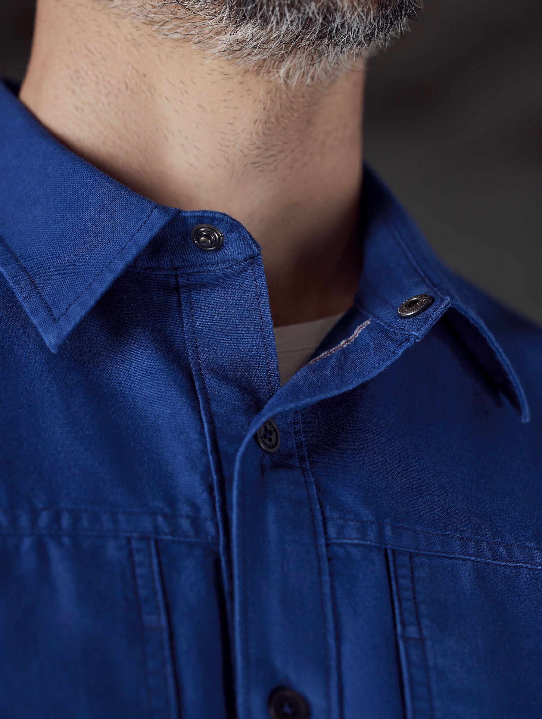 Closeup detailed view of the custom snap-secured collar on the Emerson Button Down in Dark Blue from AETHER Apparel.