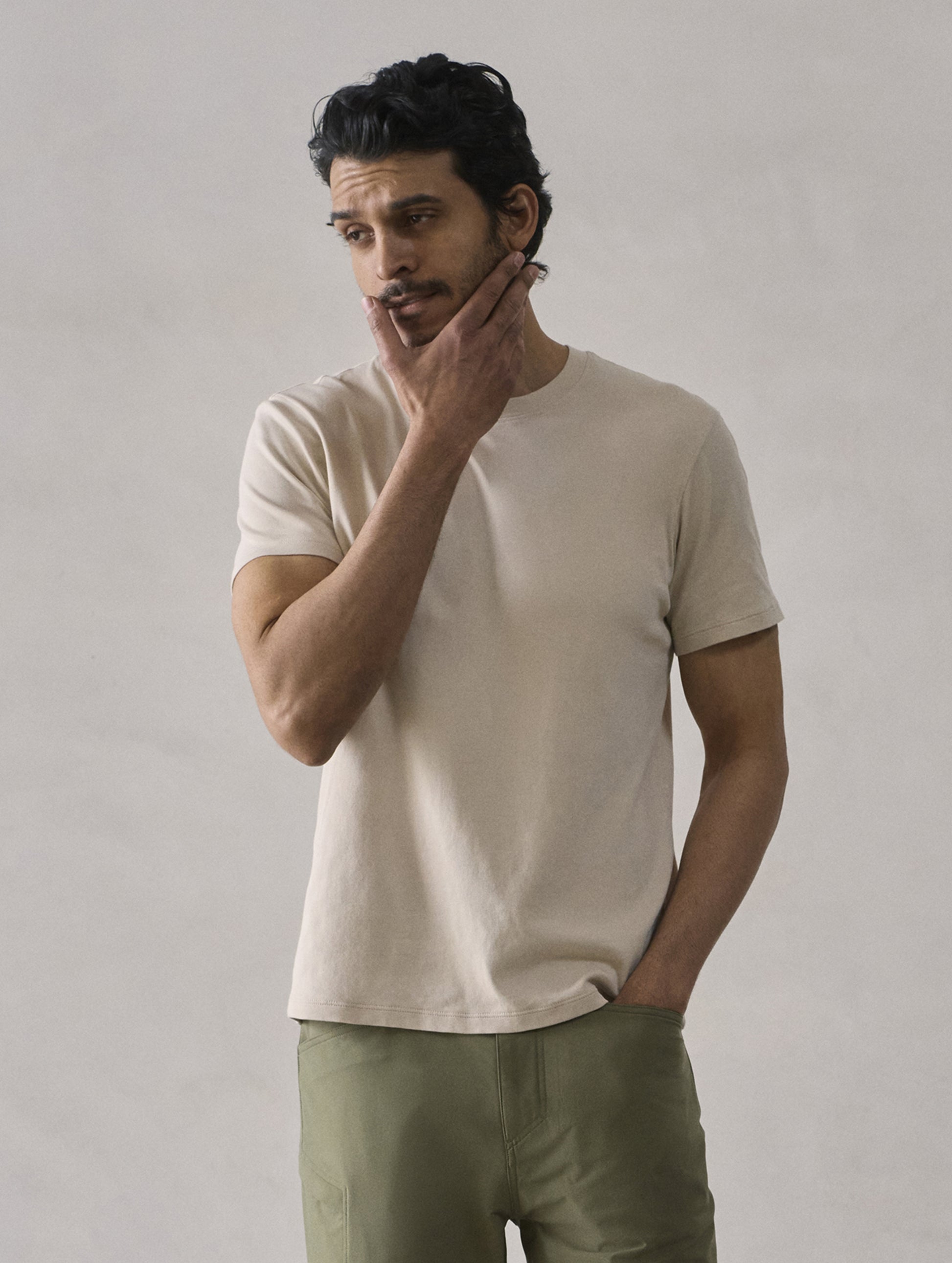Front view of man wearing Emery Pima Crew Tee in Bone white from AETHER Apparel.