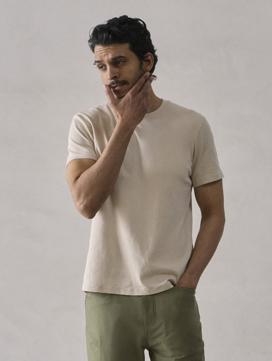 Front view of man wearing Emery Pima Crew Tee in Bone white from AETHER Apparel.