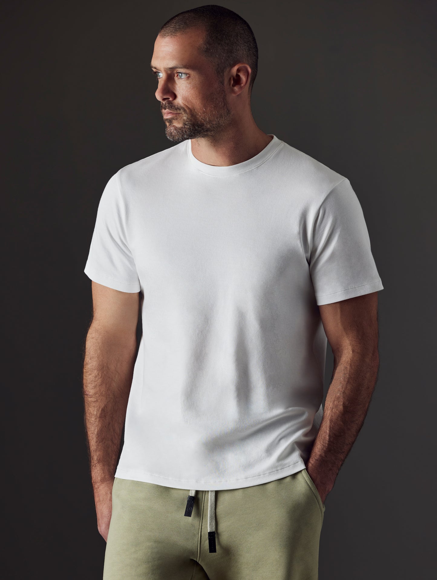 Man wearing white organic cotton tee from AETHER Apparel