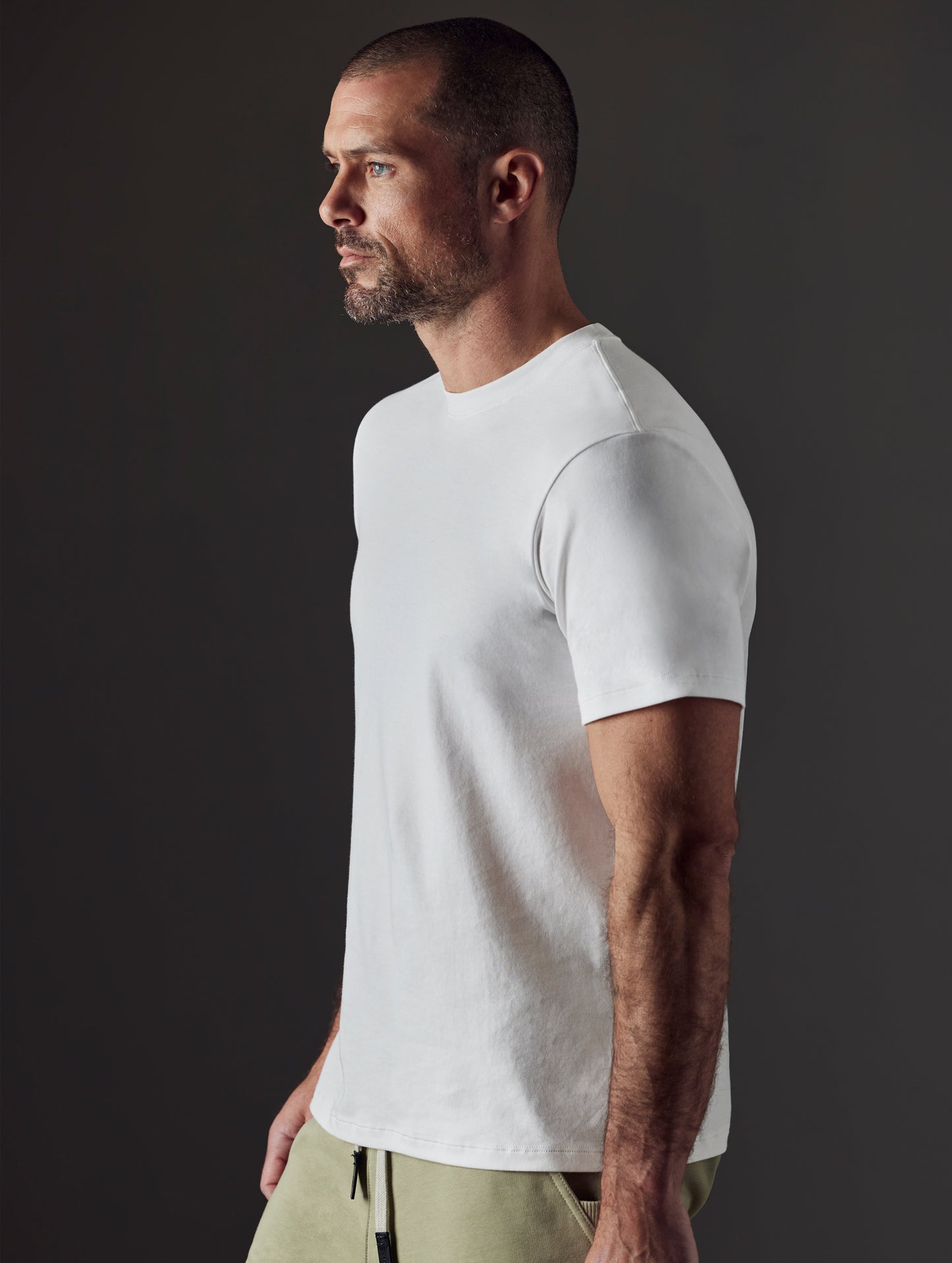 Man wearing white organic cotton tee from AETHER Apparel