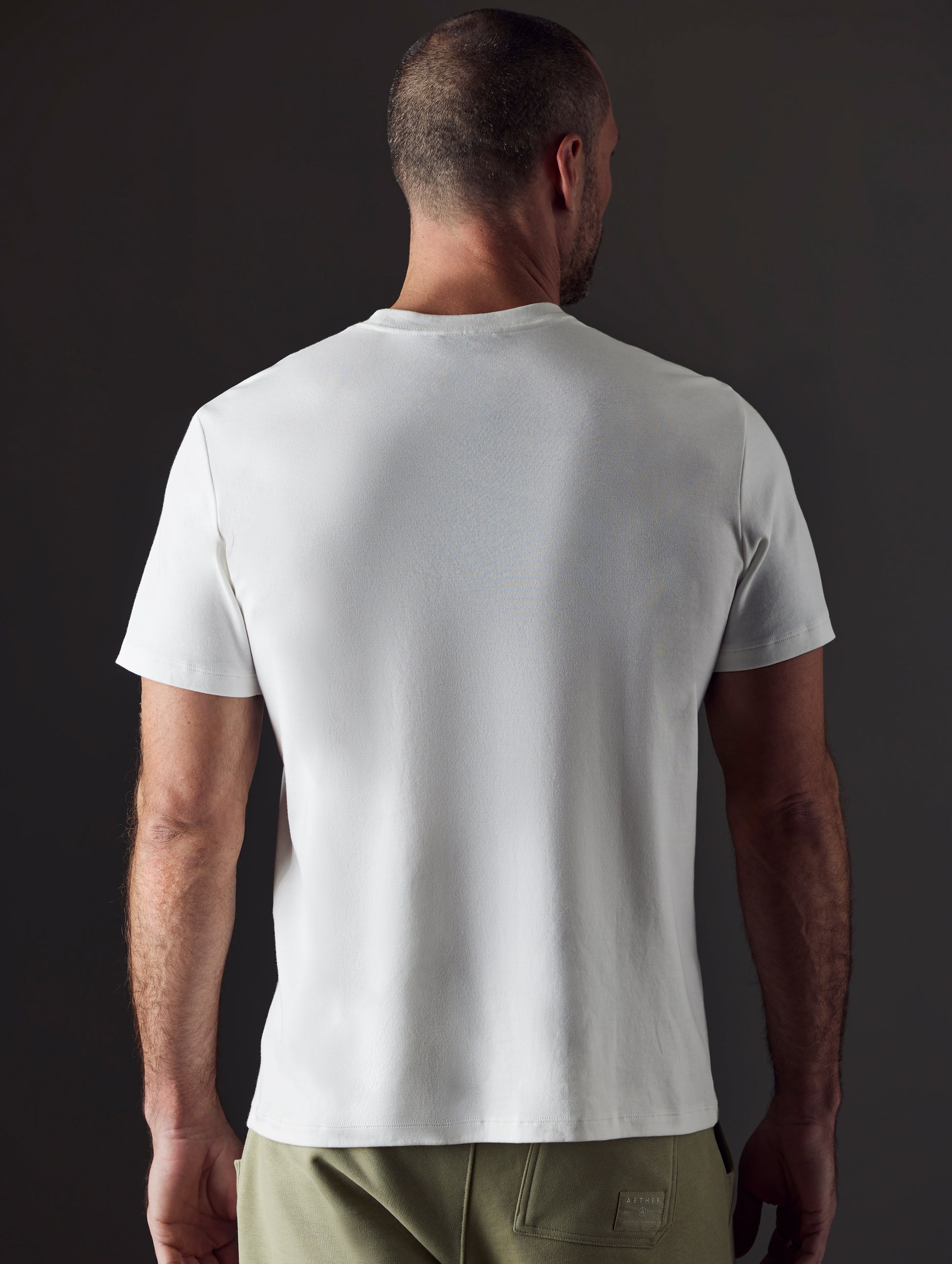 Man wearing white organic cotton tee from AETHER Apparel