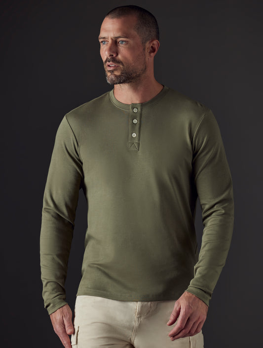 Man wearing green organic cotton henley from AETHER Apparel