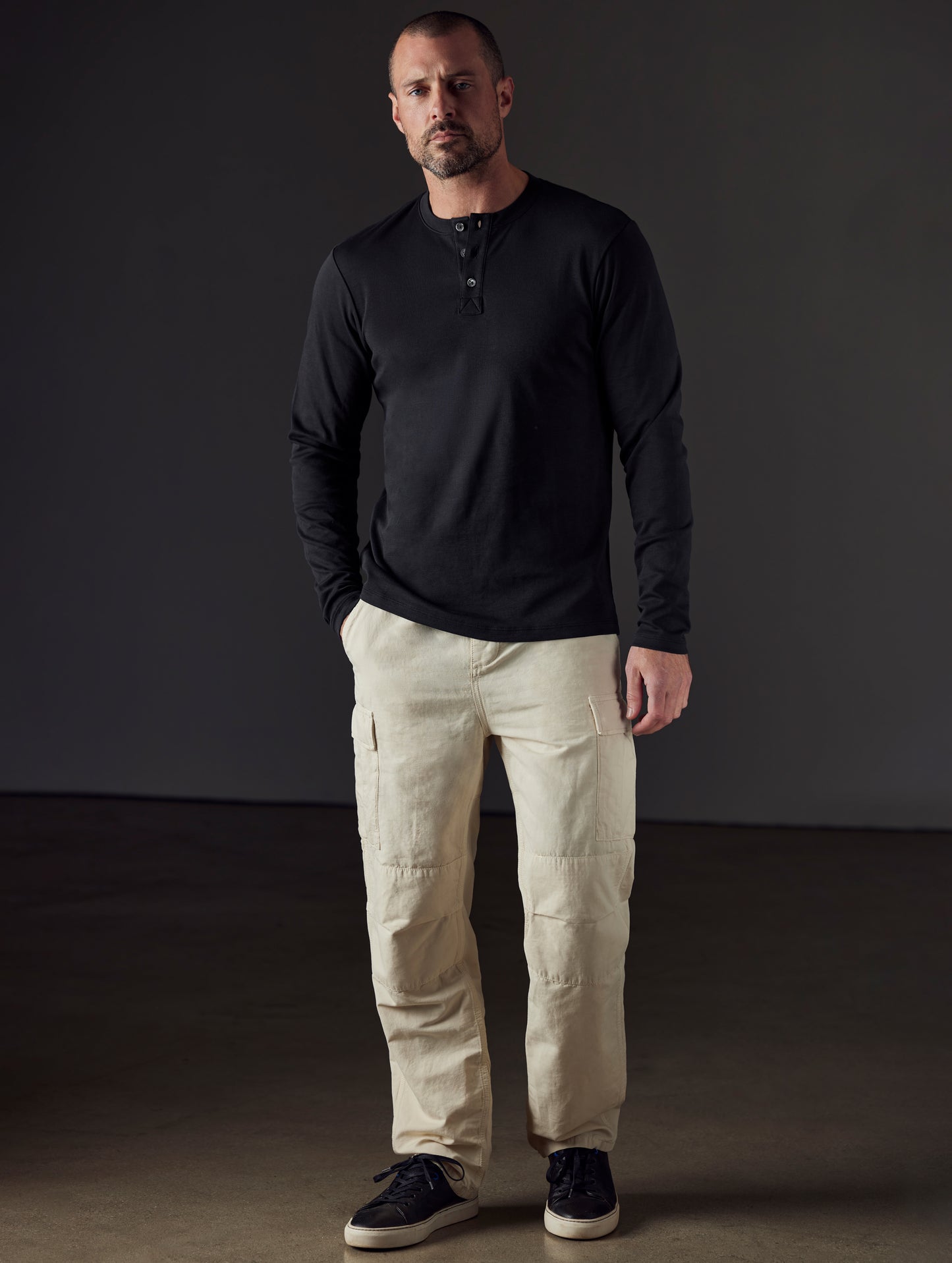 Man wearing black organic cotton henley from AETHER Apparel