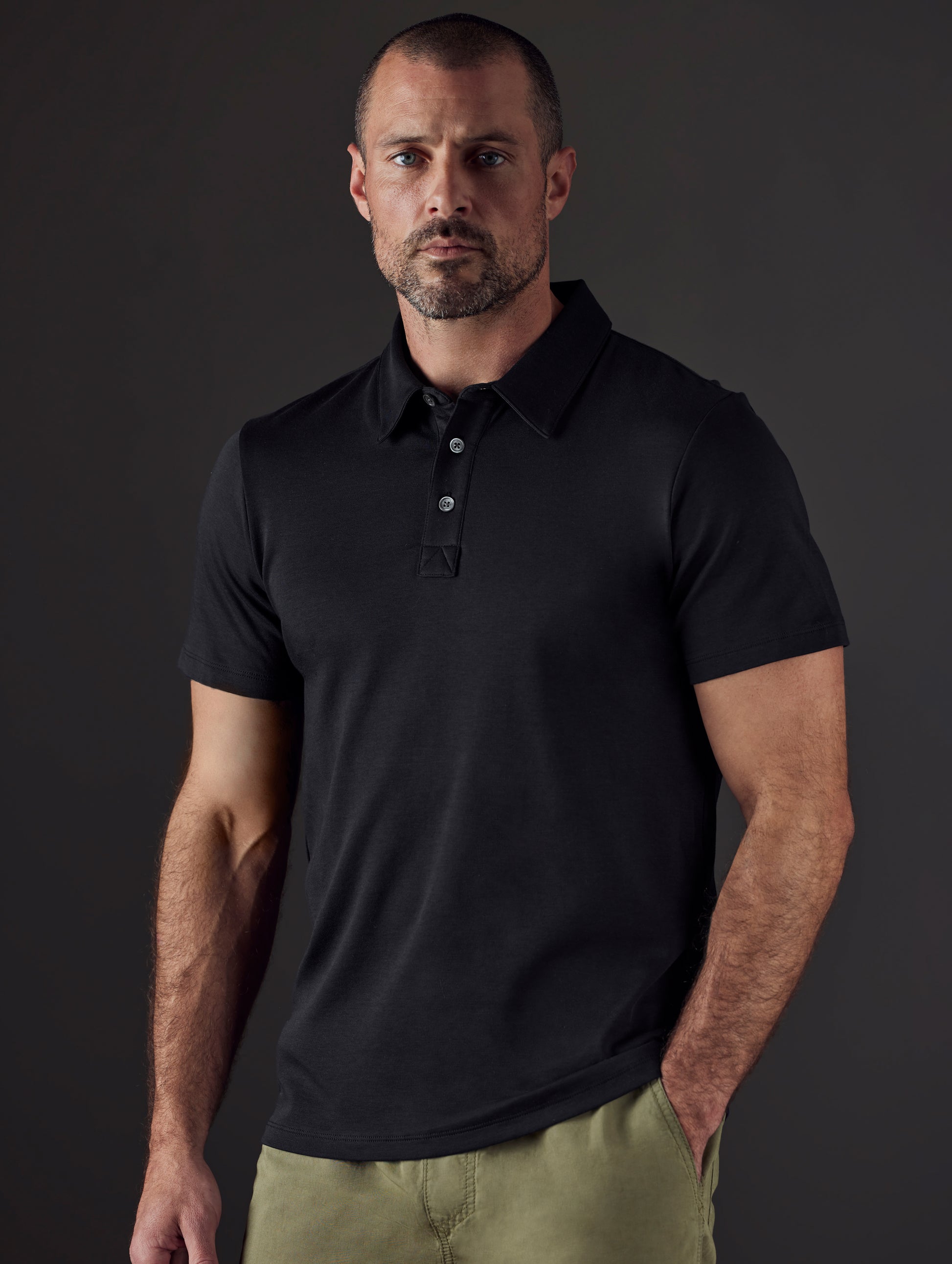 Man wearing black organic cotton polo from AETHER Apparel
