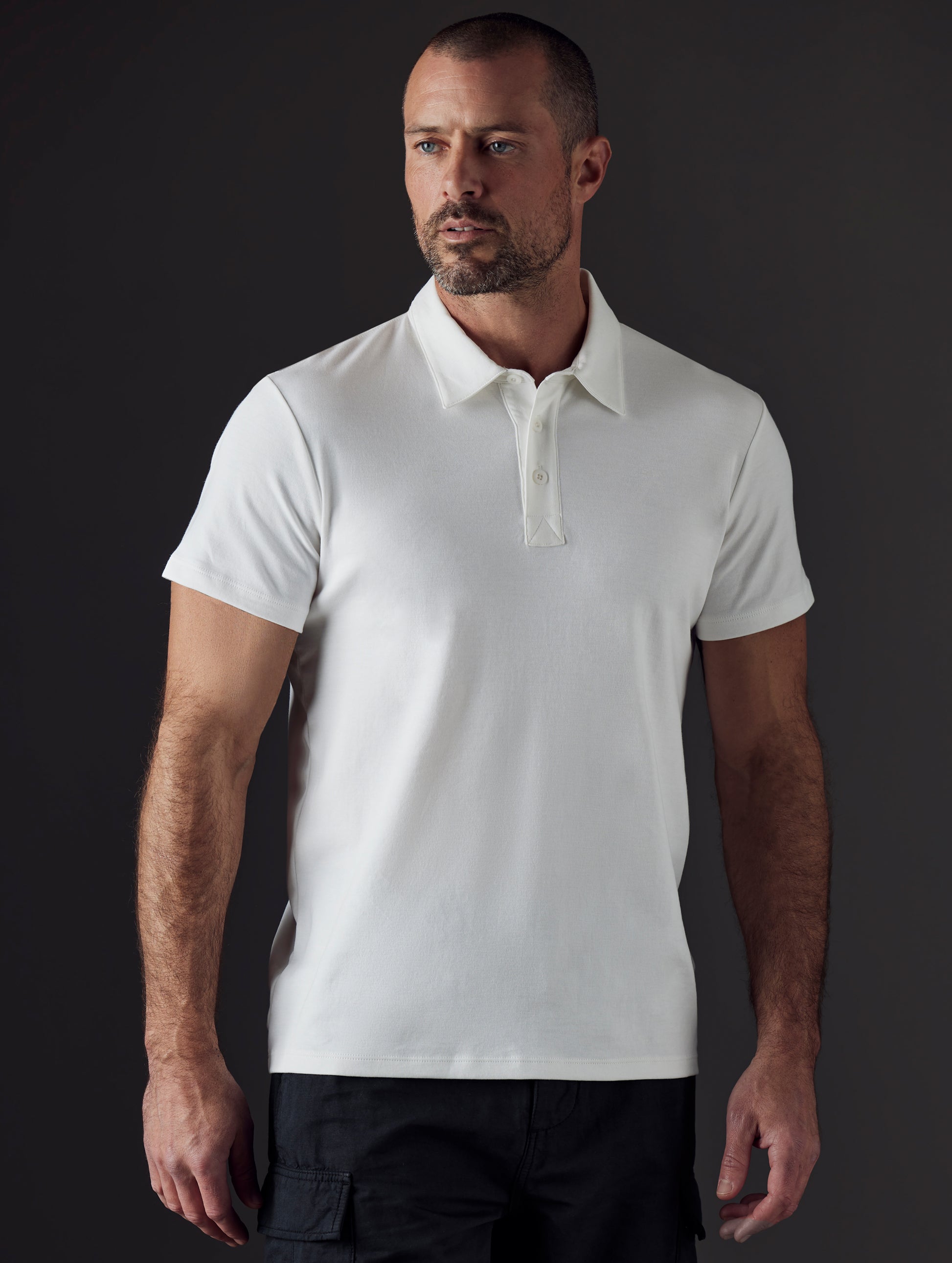 Man wearing white organic cotton polo from AETHER Apparel