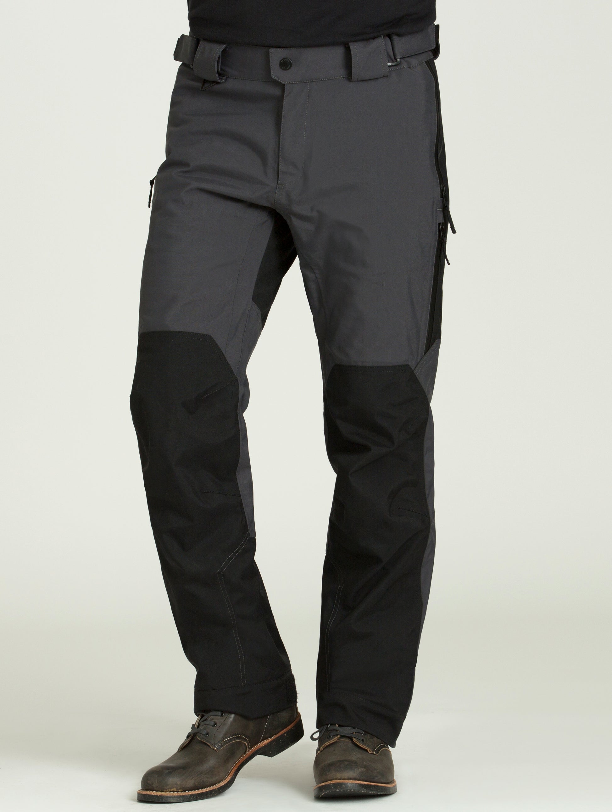 Man wearing dark grey Expedition Motorcycle Pant from AETHER Apparel.