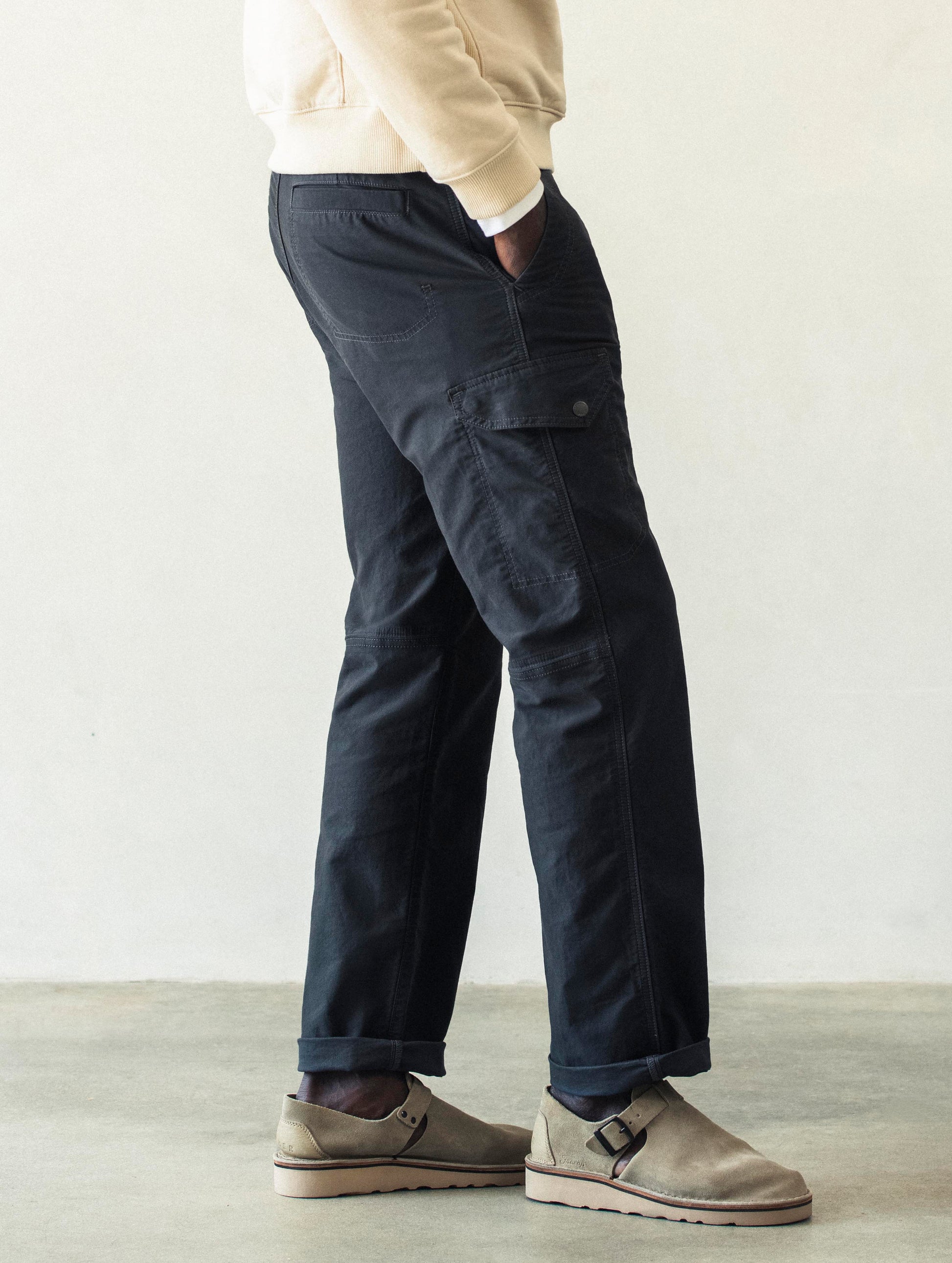 Right lower body view of man wearing Fairfax Pant 2.0 in Graphite from AETHER Apparel.