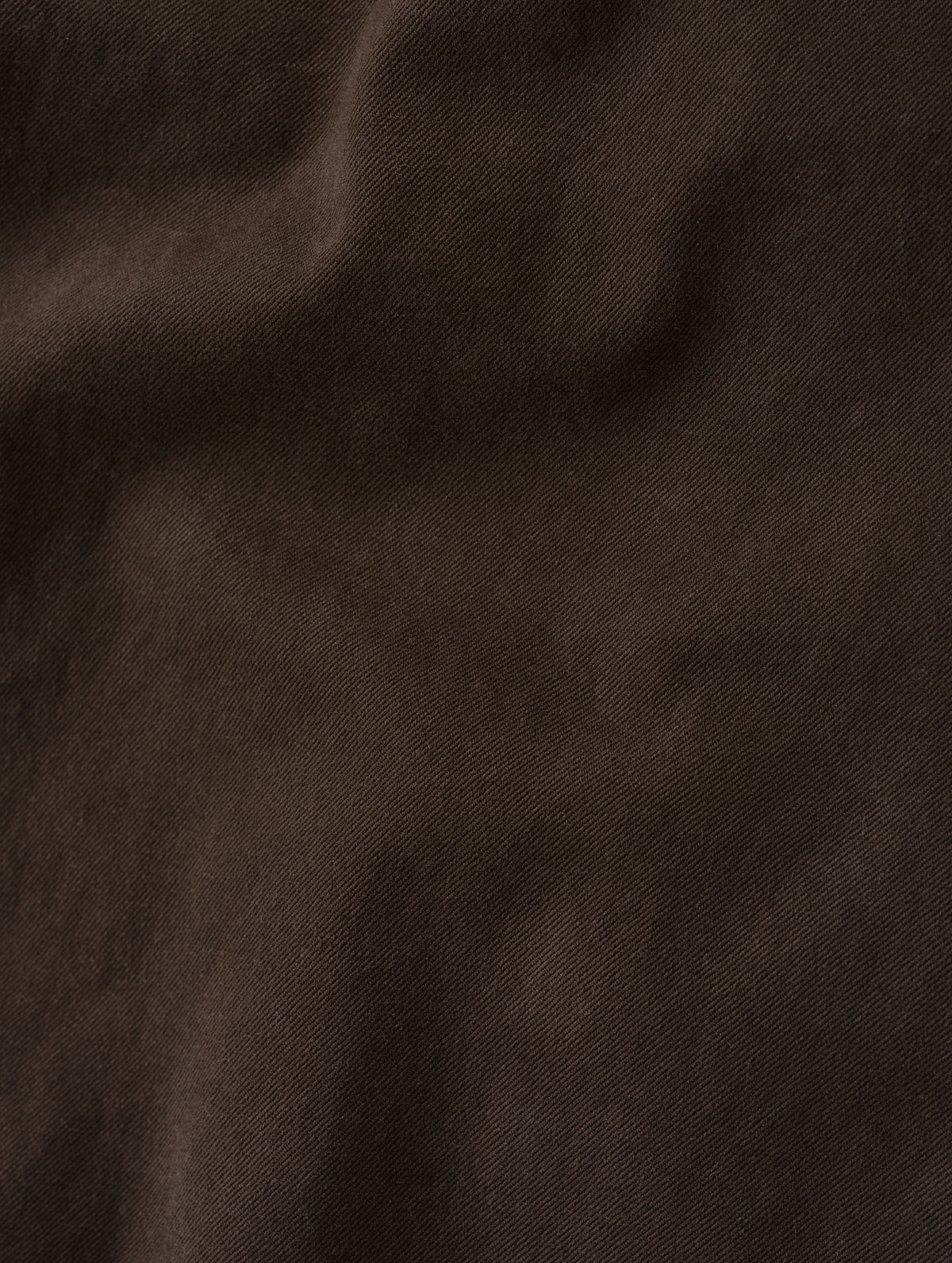 Closeup detailed view of the brushed fine twill construction on the Flint Chino Pant in Ash Brown from AETHER Apparel.