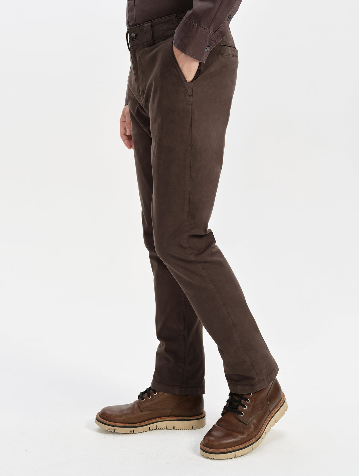 Side profile lower-body view of man wearing the Flint Chino Pant in Ash Brown from AETHER Apparel.
