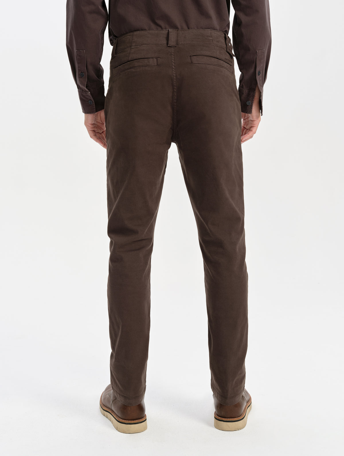 Rear lower-body view of man wearing the Flint Chino Pant in Ash Brown from AETHER Apparel.