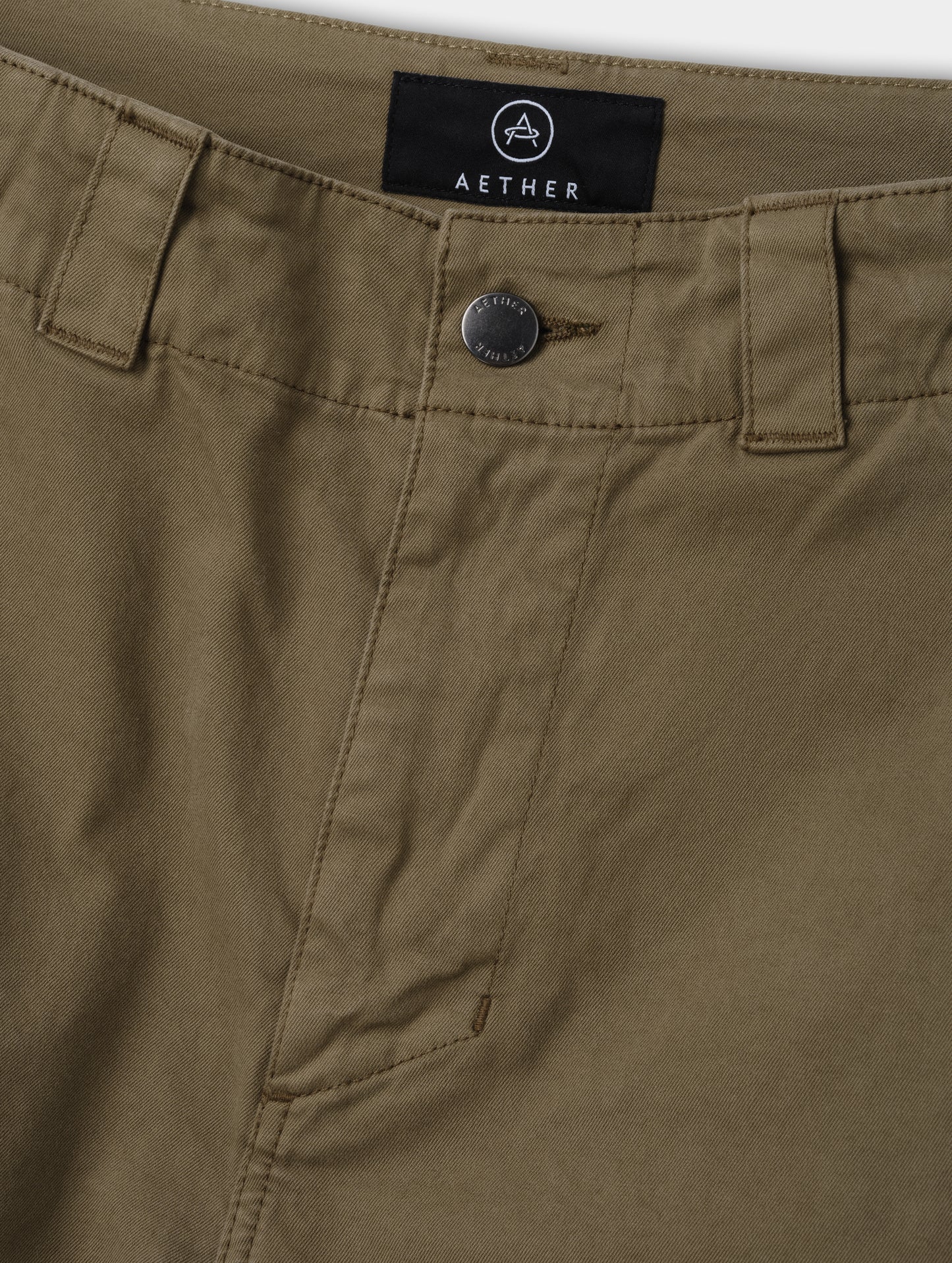 Closeup detailed view of the zippered fly and metal shank button closure on the Flint Chino Pant in Cadet from AETHER Apparel.